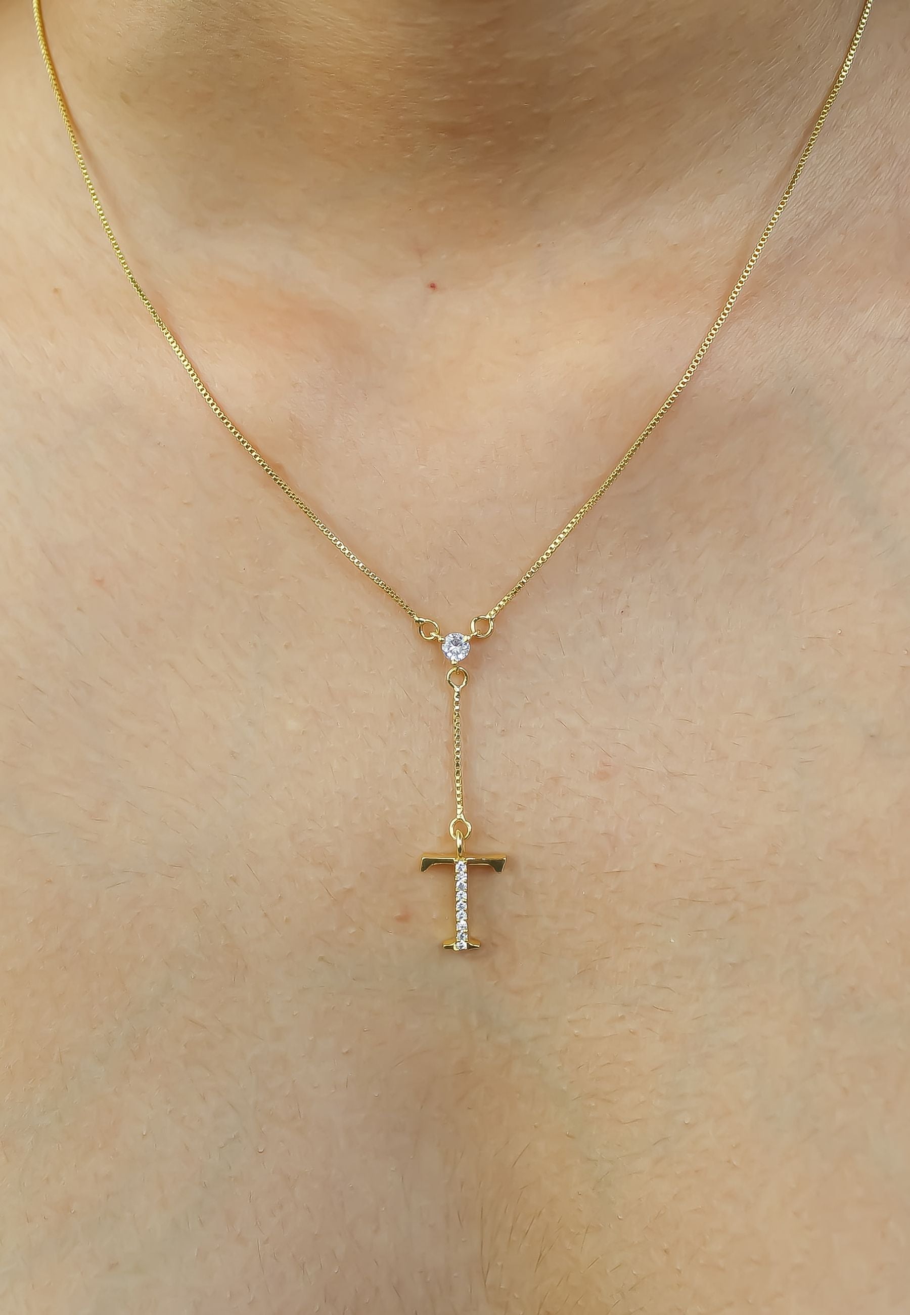 Elegant Golden Alphabet Necklace with zirconia stones, showcasing a personalized initial, perfect for layering or gifting.