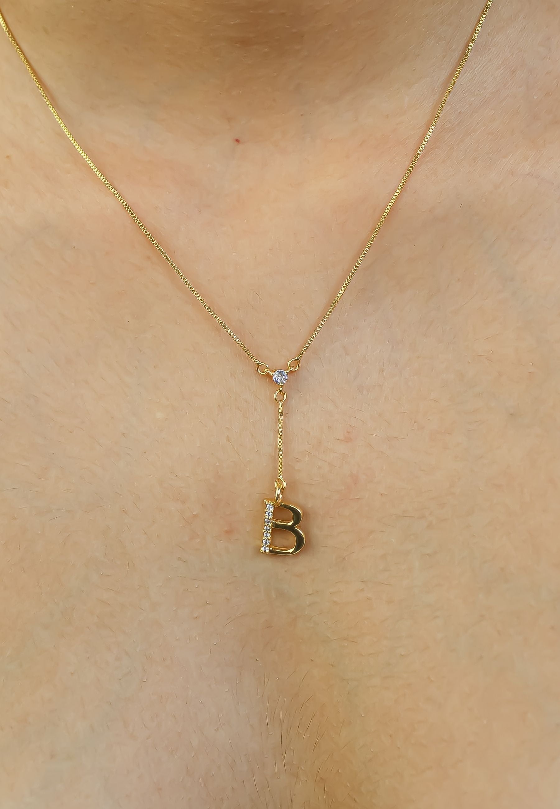 Elegant Golden Alphabet Necklace with zirconia stones, showcasing a personalized initial, perfect for layering or gifting.