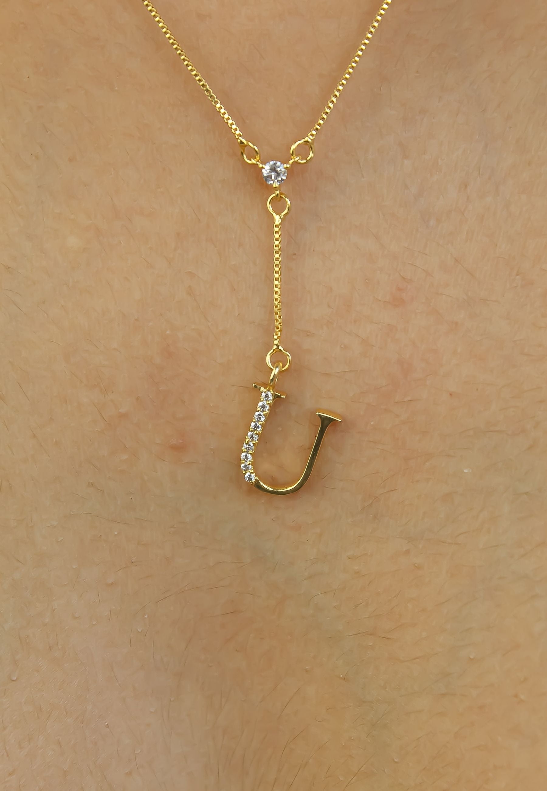 Elegant Golden Alphabet Necklace with zirconia stones, showcasing a personalized initial, perfect for layering or gifting.