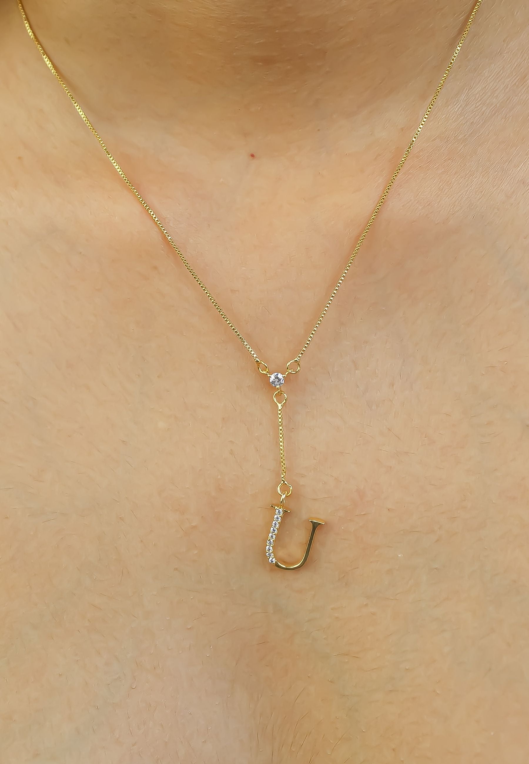 Elegant Golden Alphabet Necklace with zirconia stones, showcasing a personalized initial, perfect for layering or gifting.