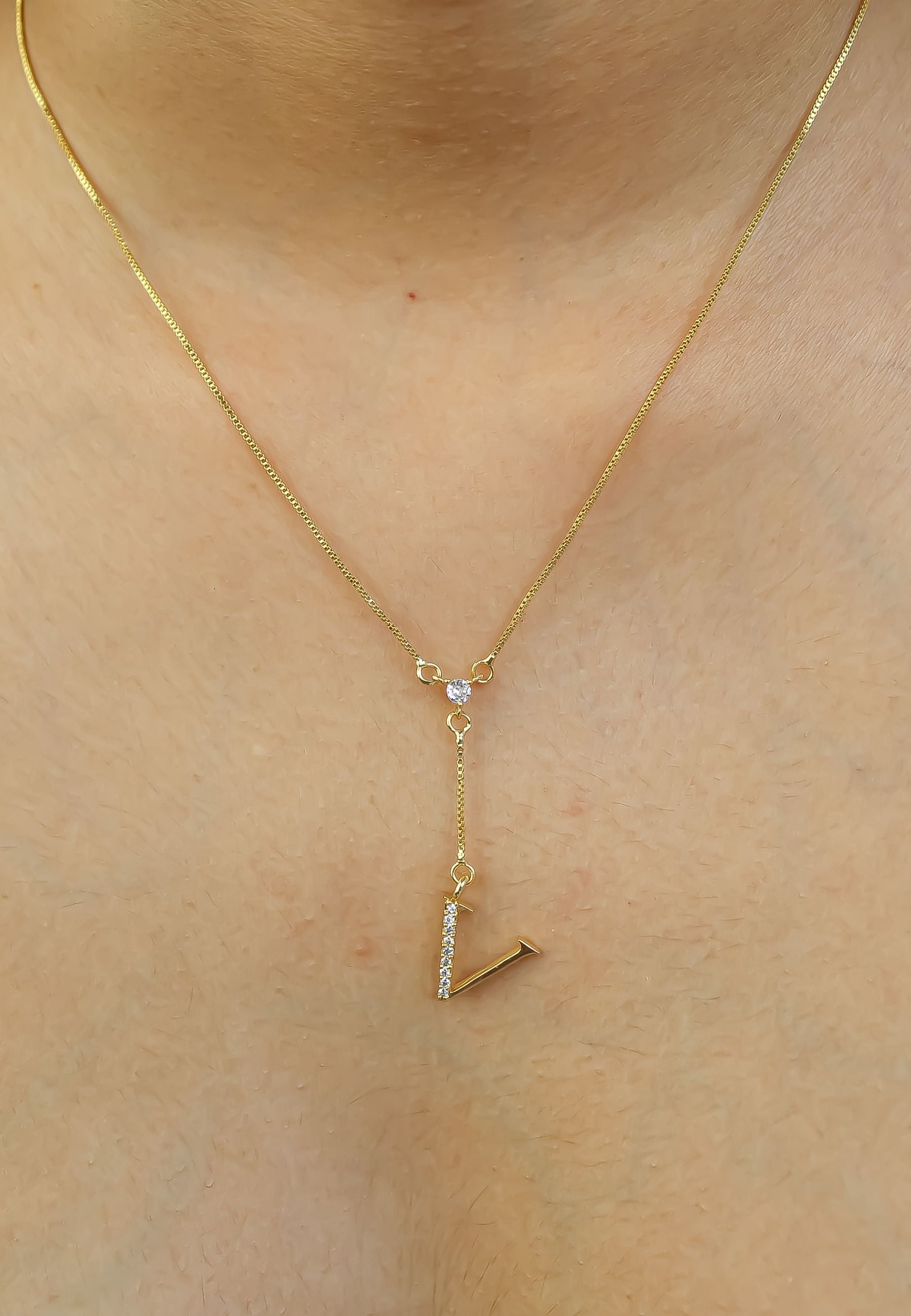 Elegant Golden Alphabet Necklace with zirconia stones, showcasing a personalized initial, perfect for layering or gifting.