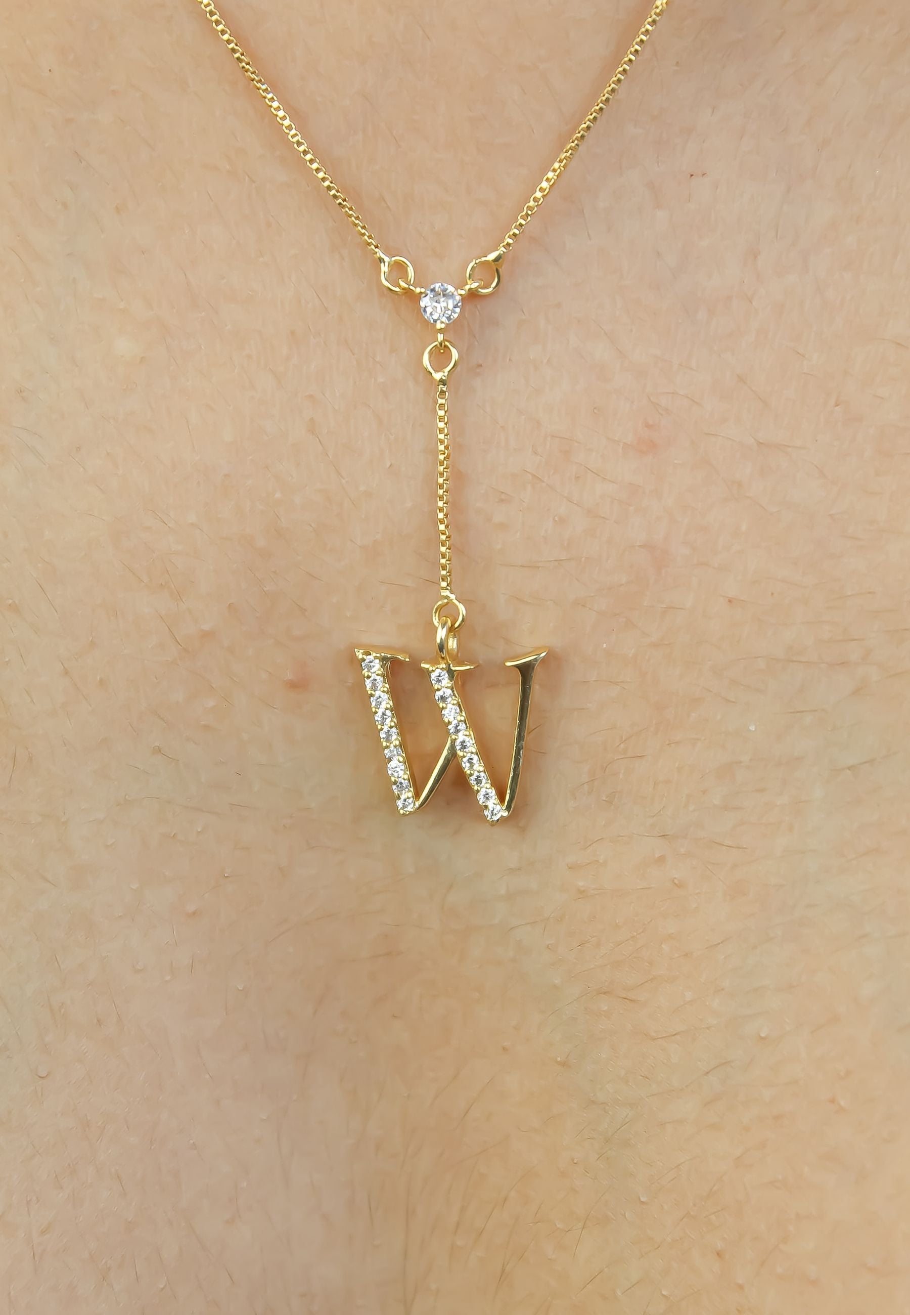 Elegant Golden Alphabet Necklace with zirconia stones, showcasing a personalized initial, perfect for layering or gifting.