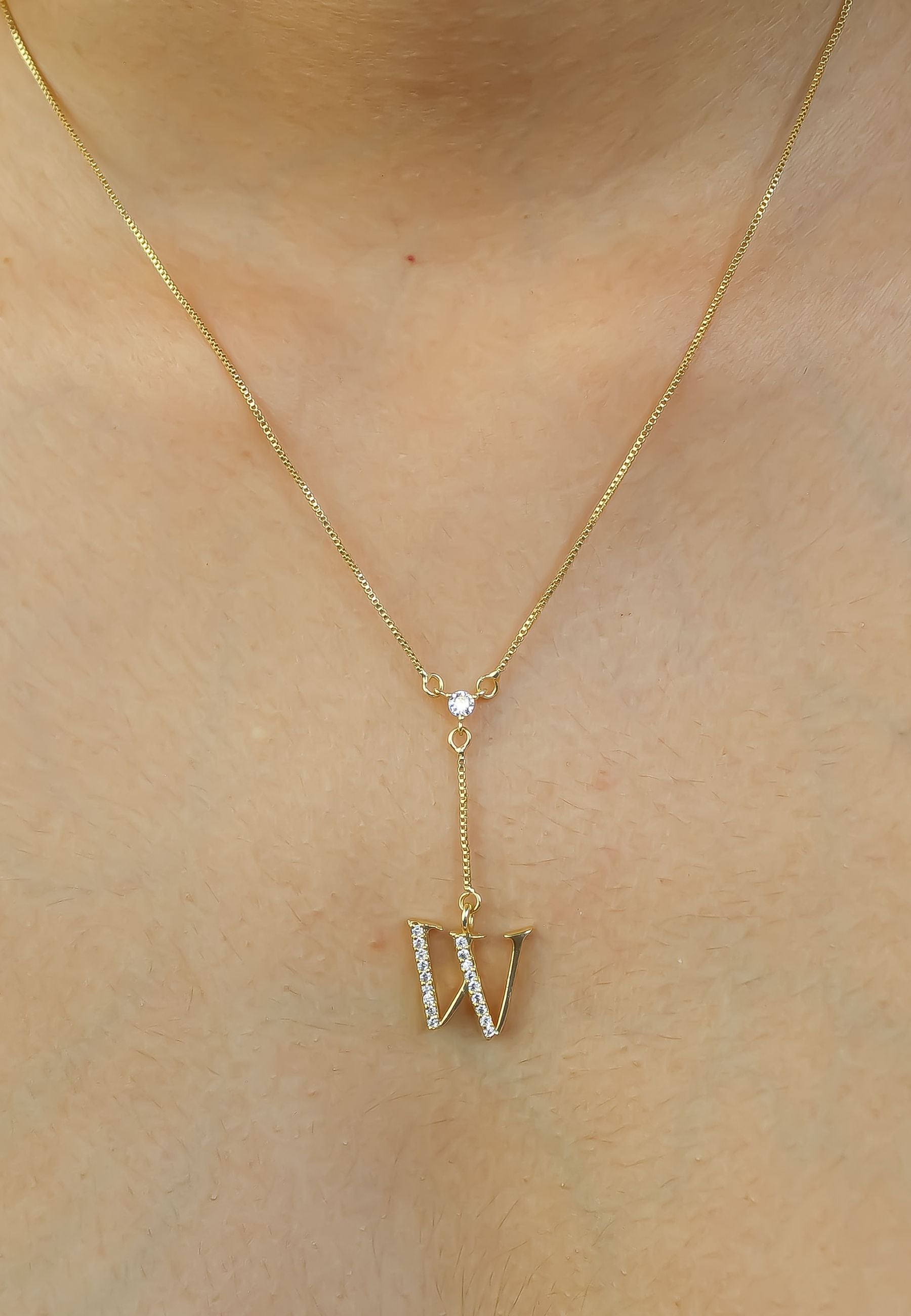 Elegant Golden Alphabet Necklace with zirconia stones, showcasing a personalized initial, perfect for layering or gifting.