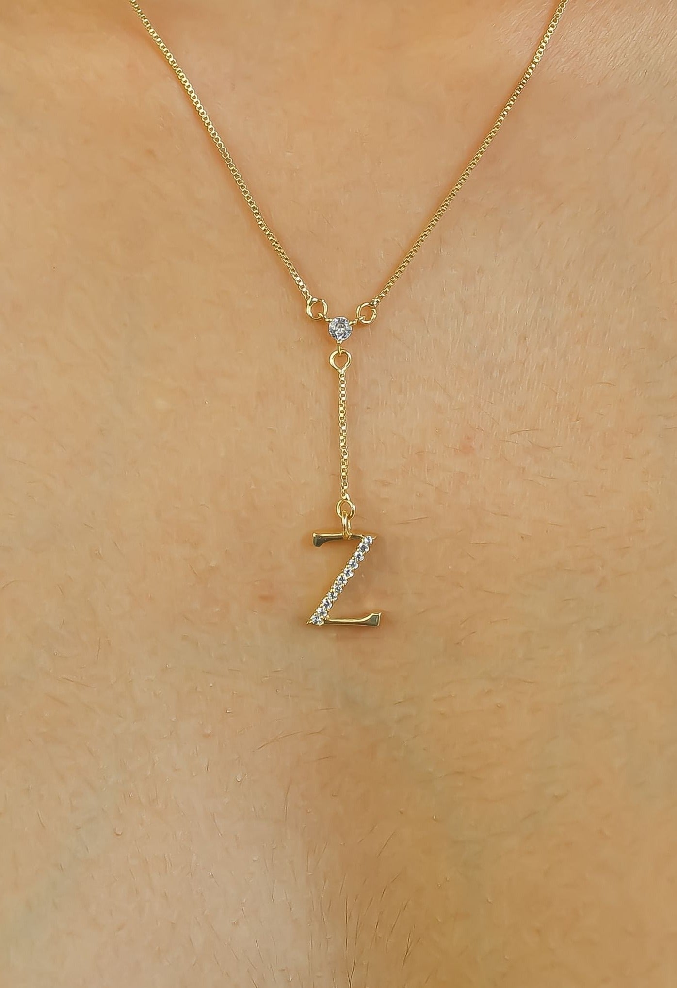 Elegant Golden Alphabet Necklace with zirconia stones, showcasing a personalized initial, perfect for layering or gifting.