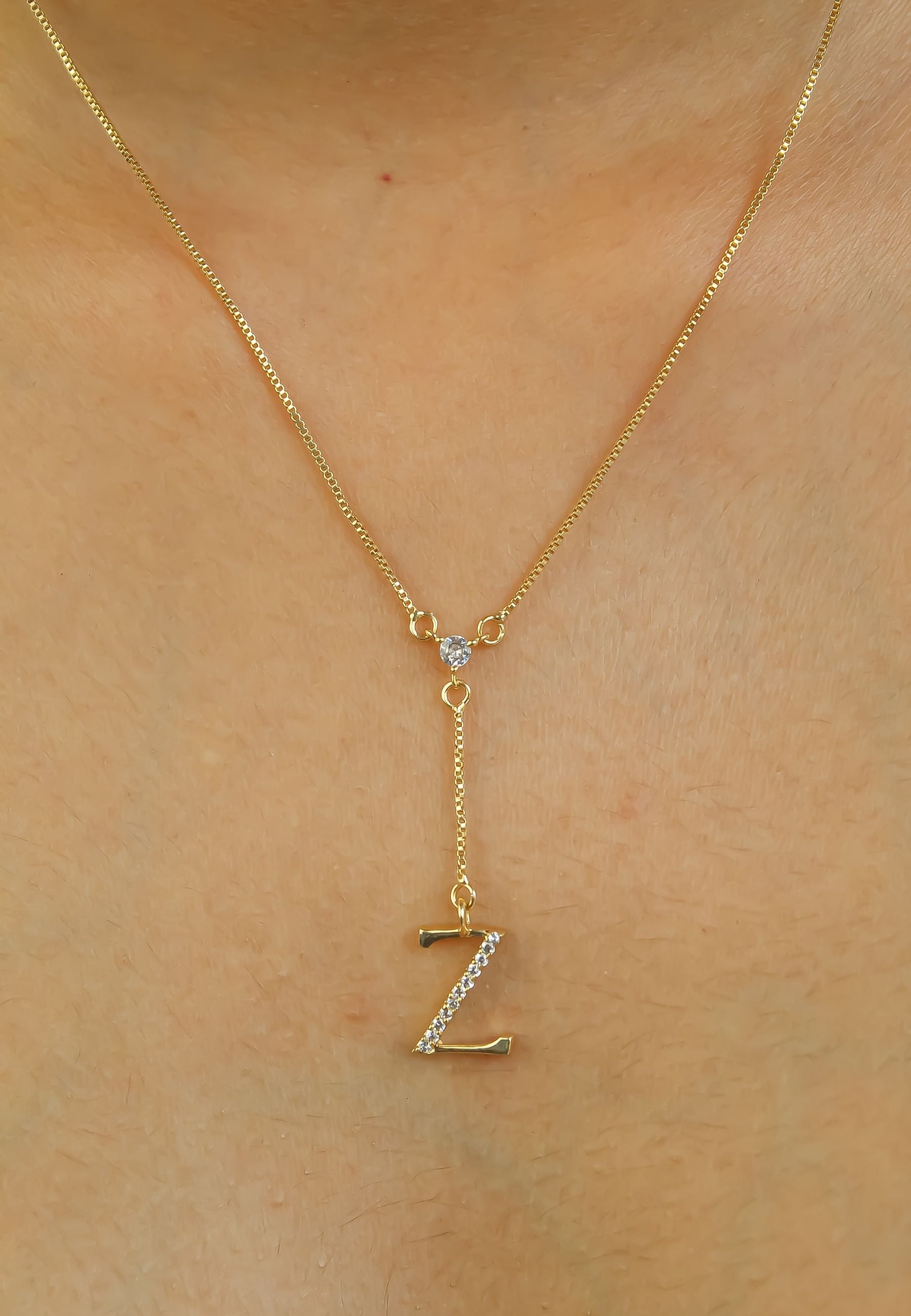 Elegant Golden Alphabet Necklace with zirconia stones, showcasing a personalized initial, perfect for layering or gifting.