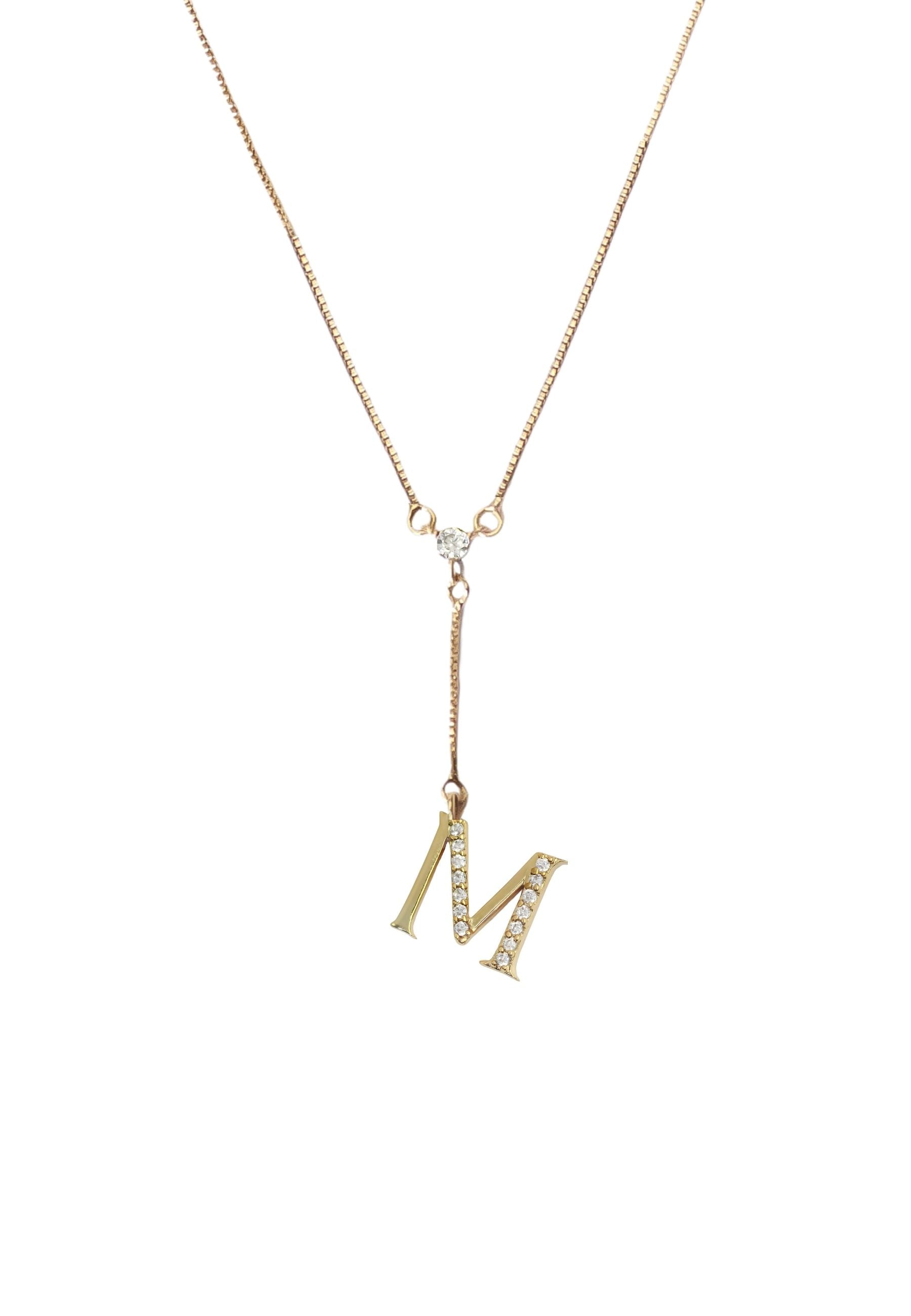 Elegant Golden Alphabet Necklace with zirconia stones, showcasing a personalized initial, perfect for layering or gifting.