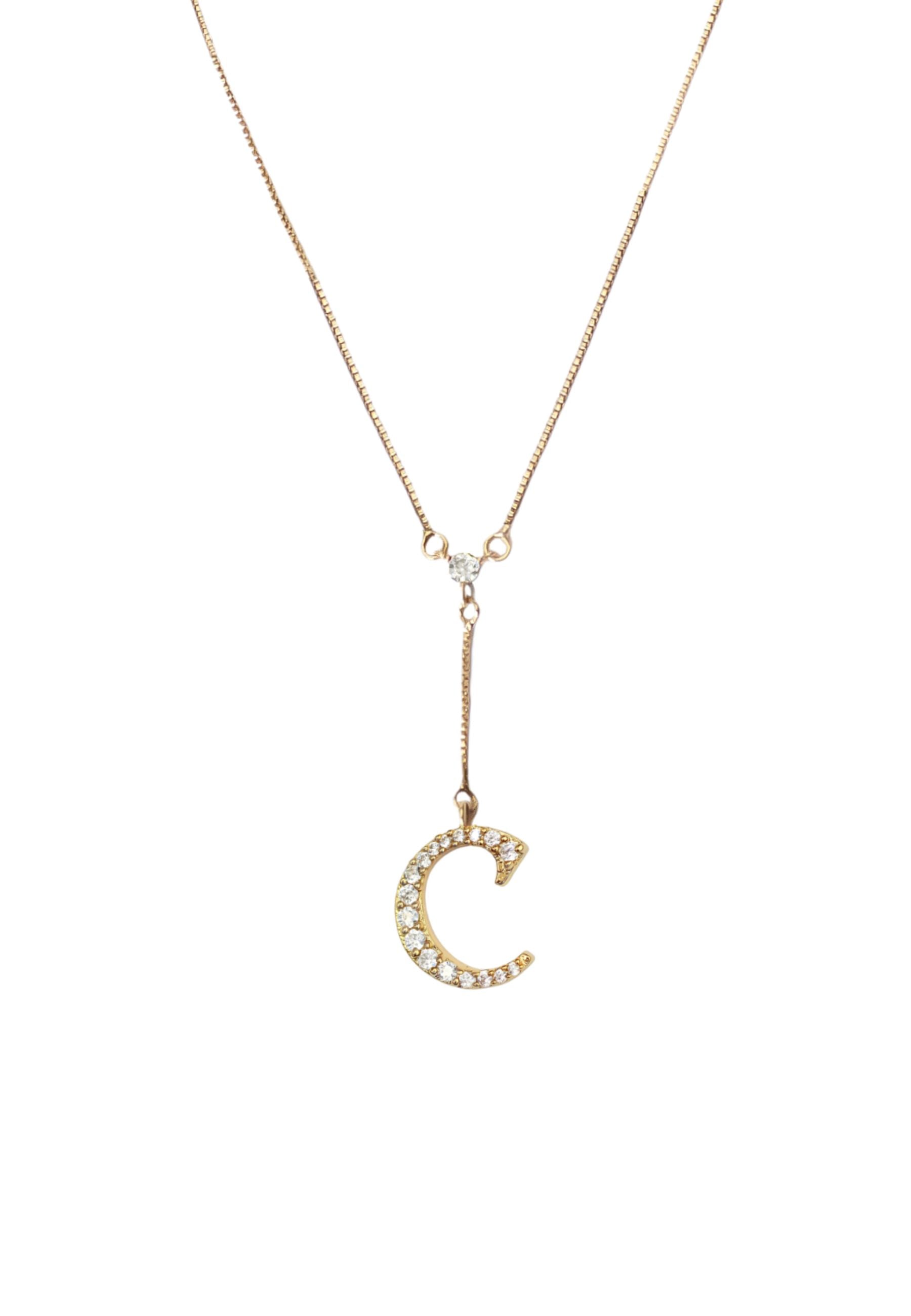 Elegant Golden Alphabet Necklace with zirconia stones, showcasing a personalized initial, perfect for layering or gifting.