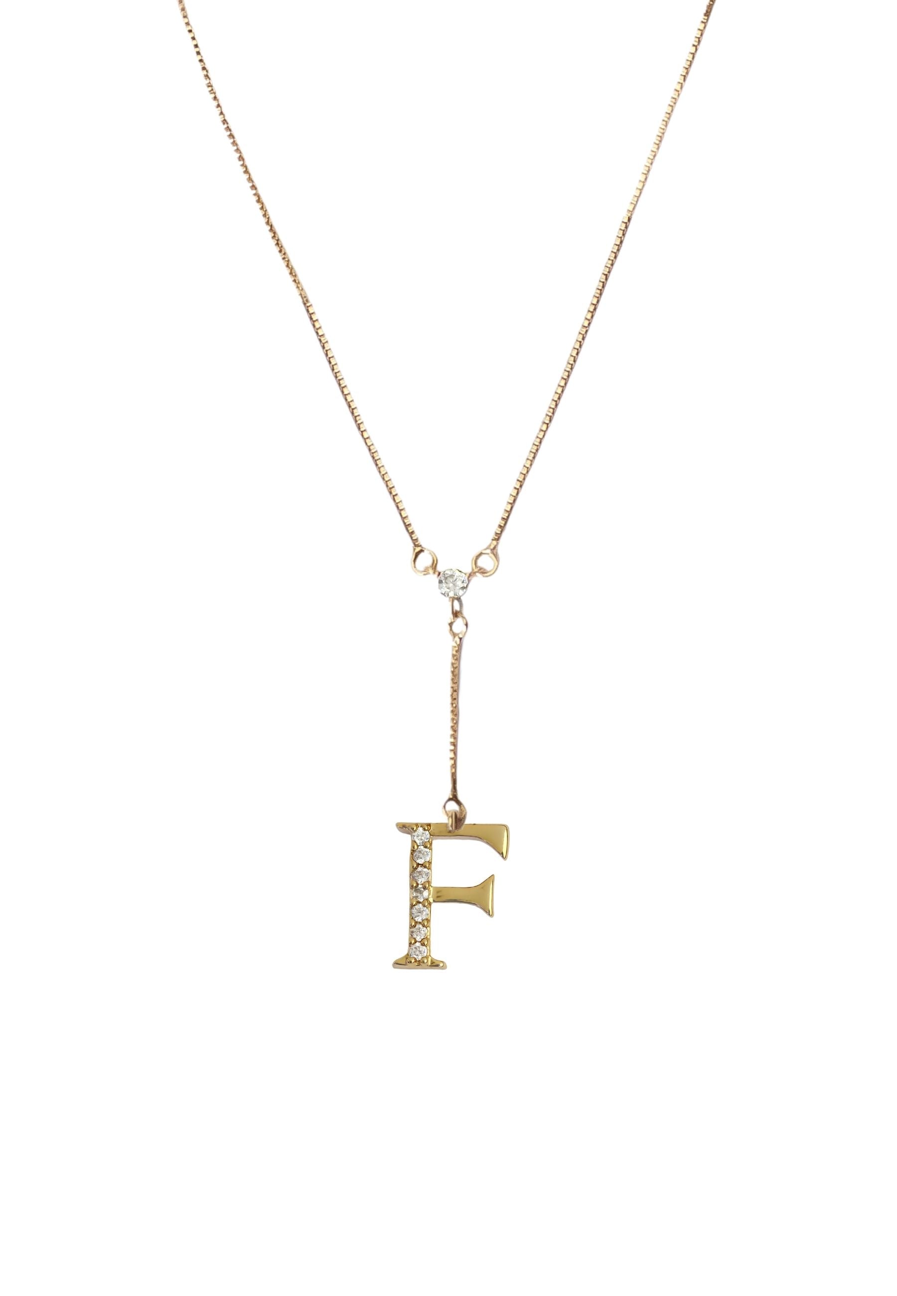 Elegant Golden Alphabet Necklace with zirconia stones, showcasing a personalized initial, perfect for layering or gifting.