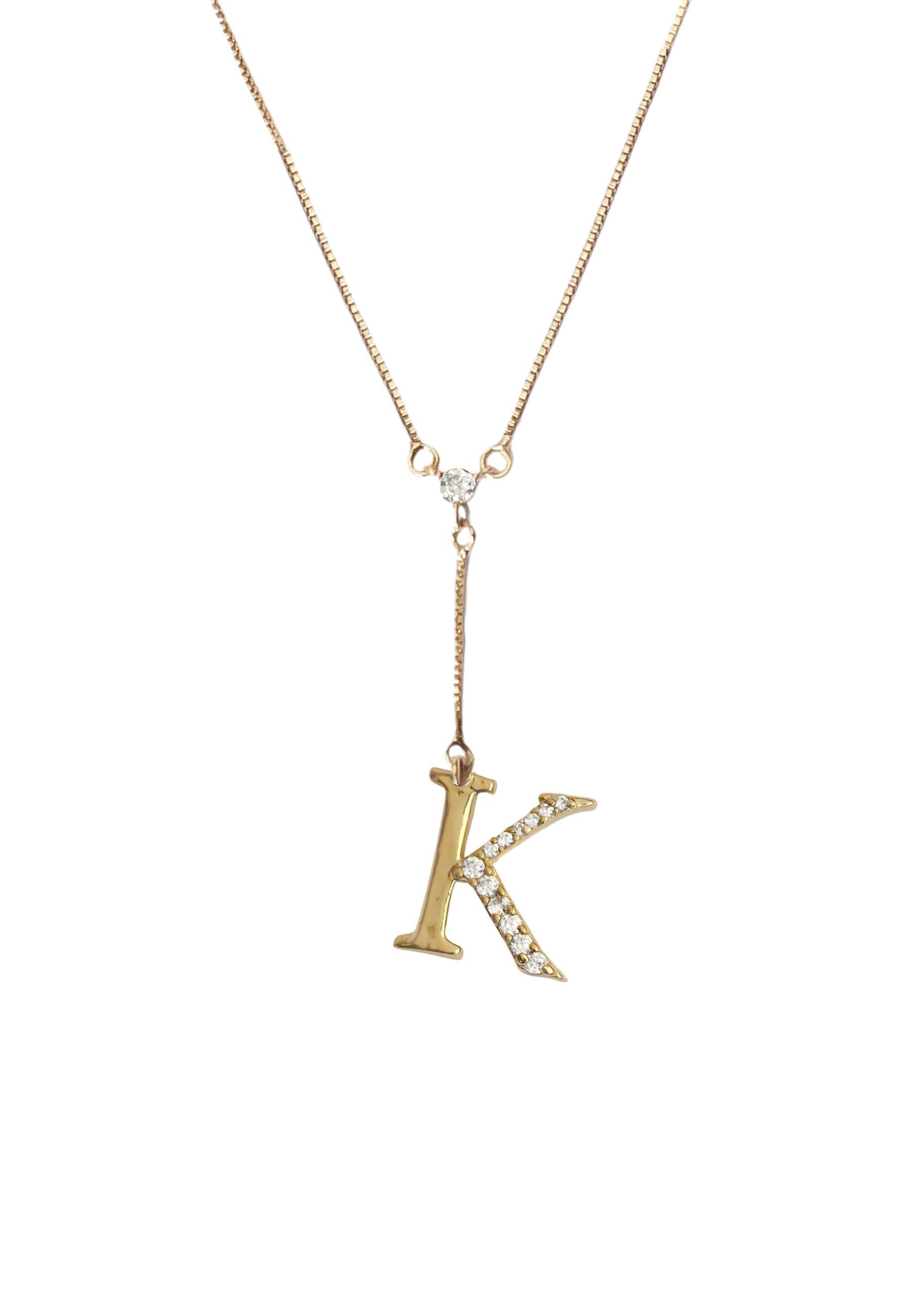 Elegant Golden Alphabet Necklace with zirconia stones, showcasing a personalized initial, perfect for layering or gifting.