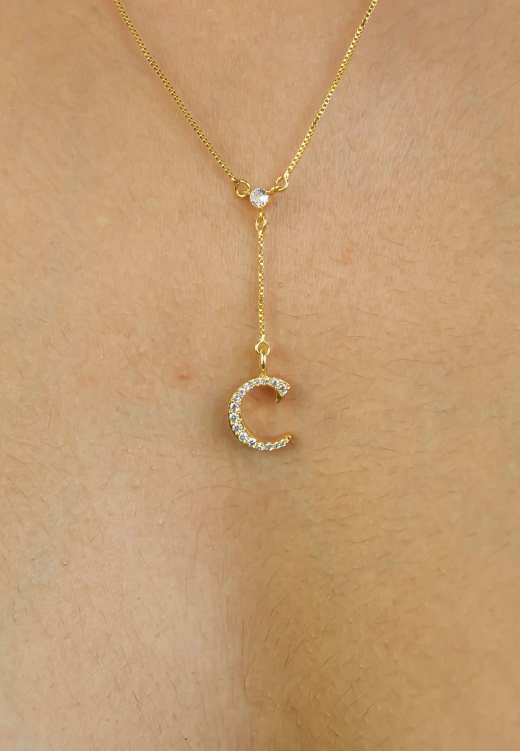 Elegant Golden Alphabet Necklace with zirconia stones, showcasing a personalized initial, perfect for layering or gifting.