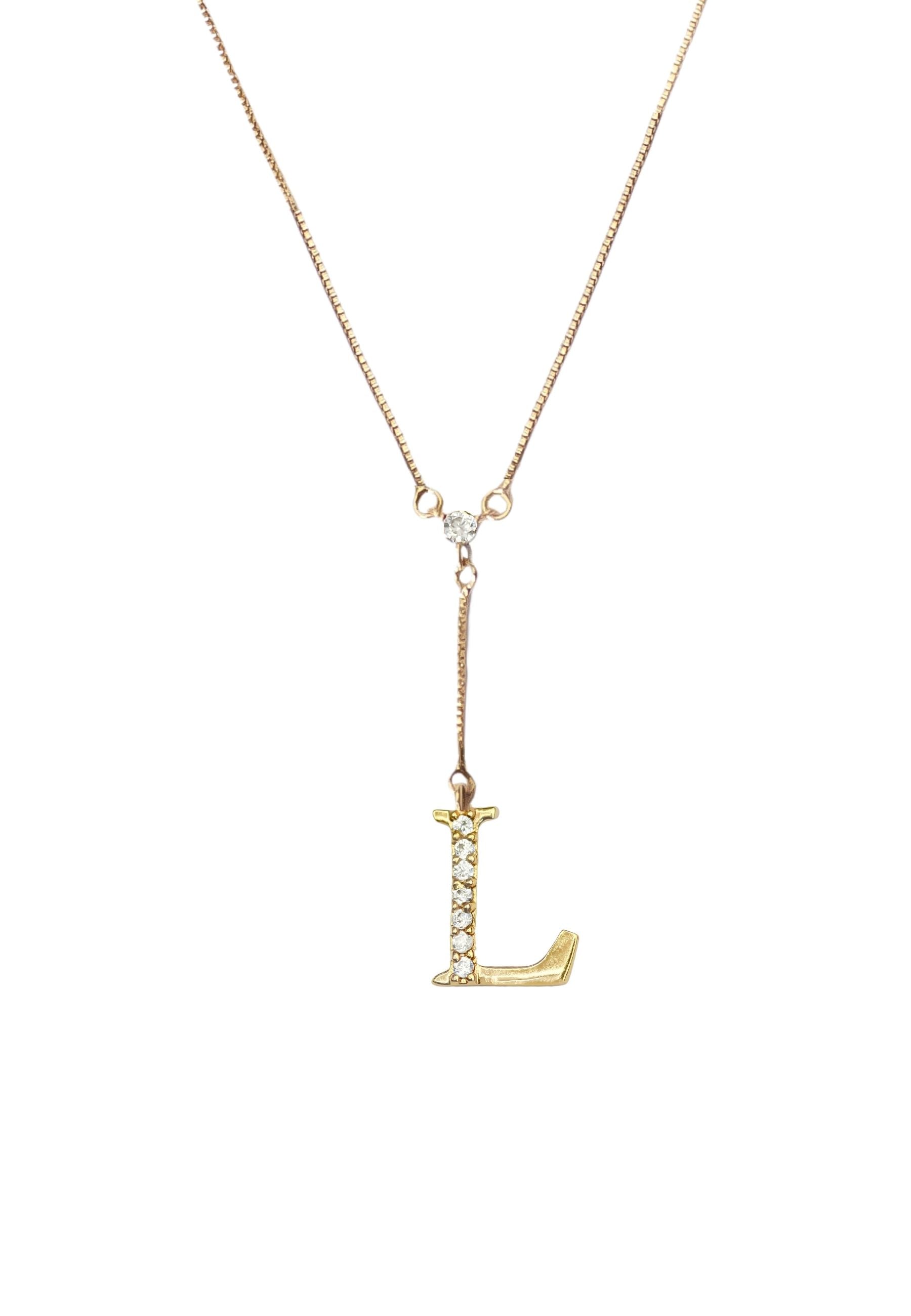 Elegant Golden Alphabet Necklace with zirconia stones, showcasing a personalized initial, perfect for layering or gifting.