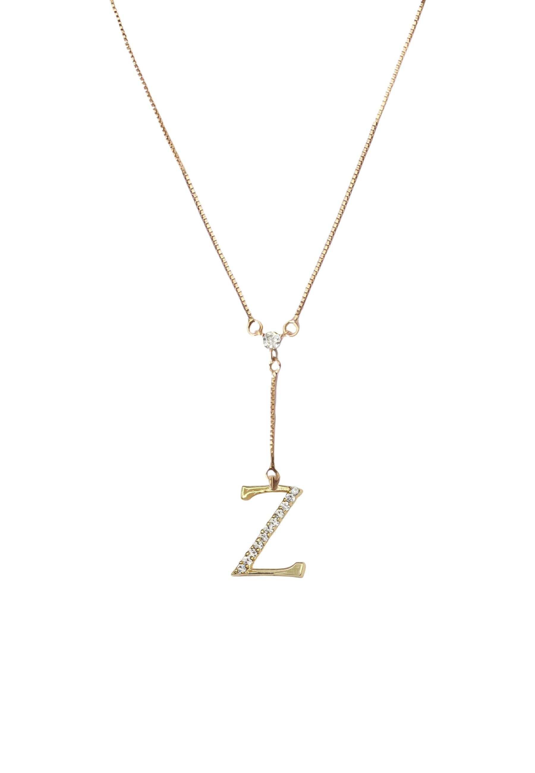 Elegant Golden Alphabet Necklace with zirconia stones, showcasing a personalized initial, perfect for layering or gifting.