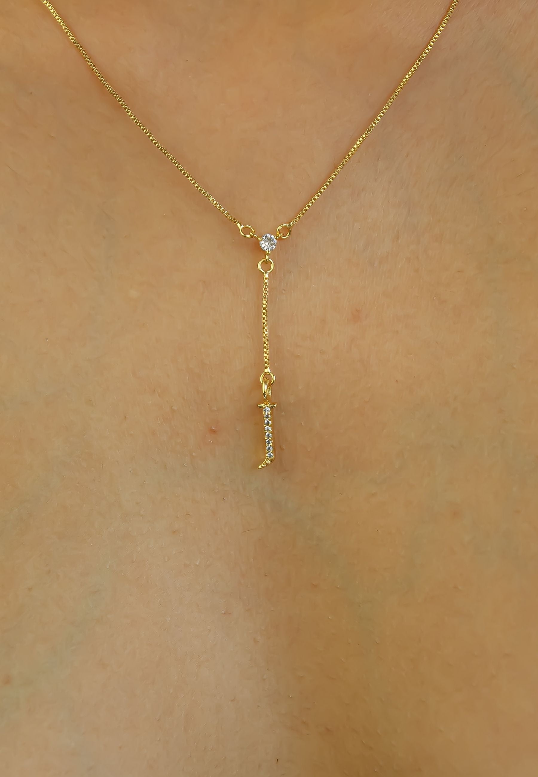 Elegant Golden Alphabet Necklace with zirconia stones, showcasing a personalized initial, perfect for layering or gifting.