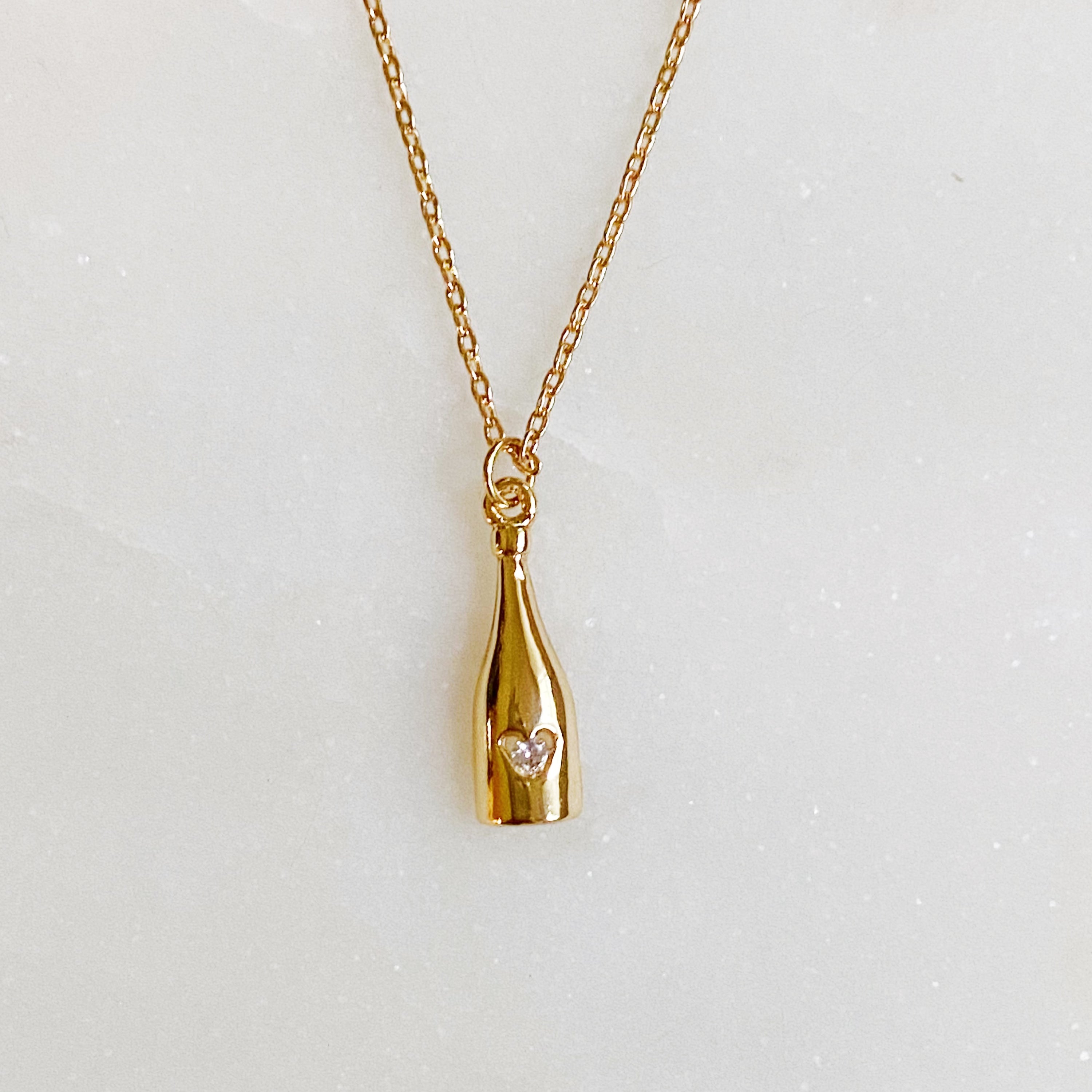 Golden Champagne Pendant Necklace featuring a sparkling pendant on a gold plated chain.