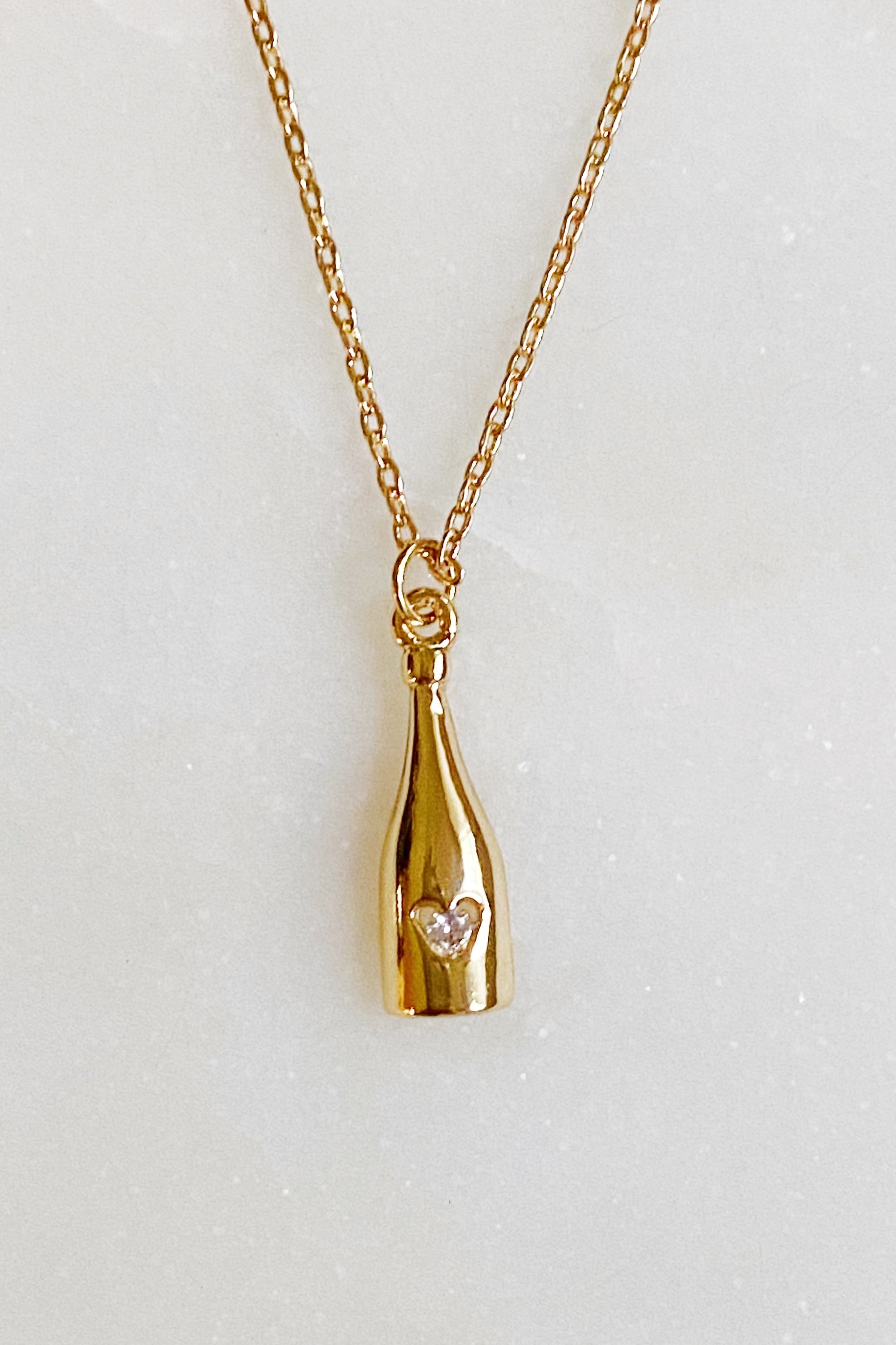 Golden Champagne Pendant Necklace featuring a sparkling pendant on a gold plated chain.