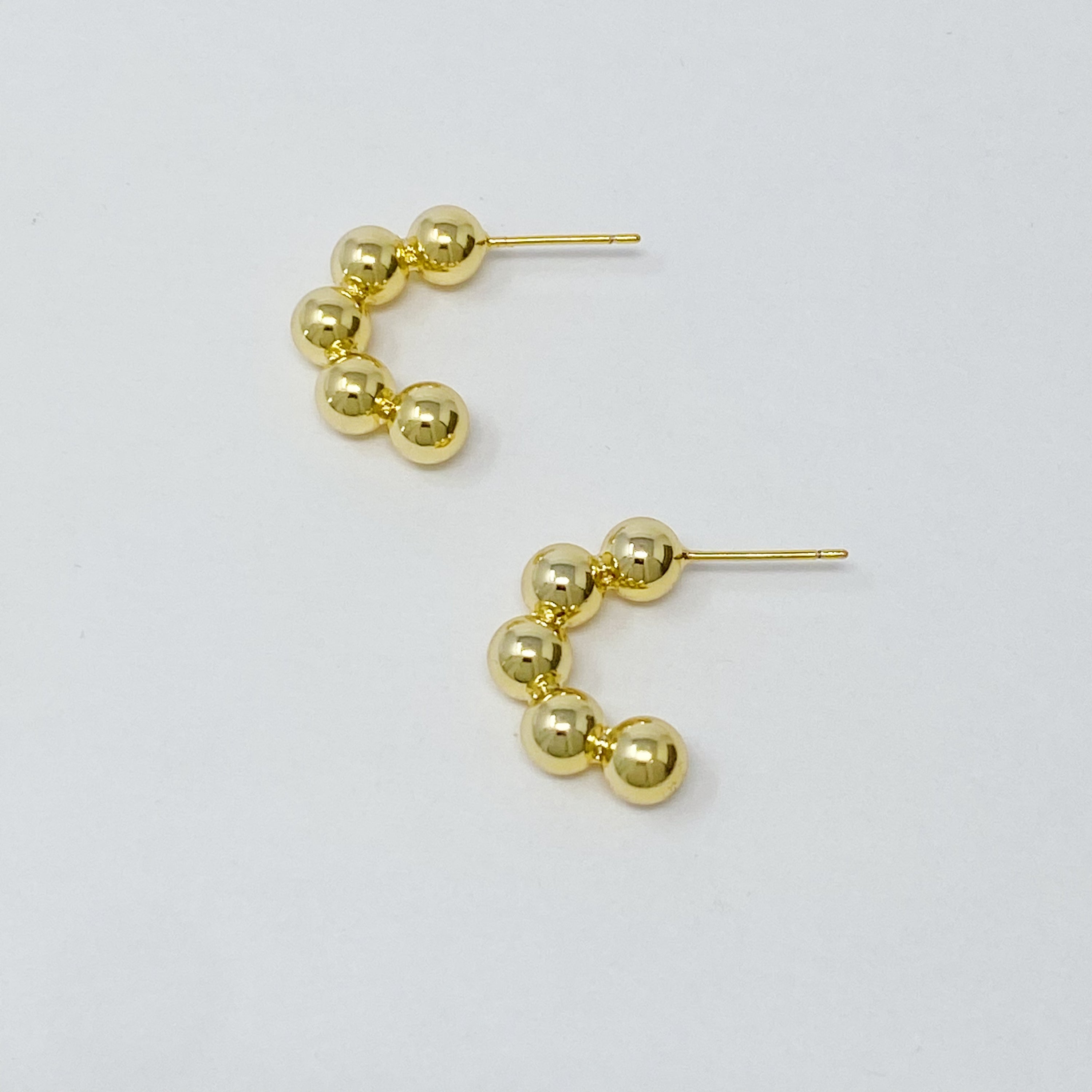 Elegant Golden Dots Hoop Earrings made of 18K gold plated brass, featuring a chic and edgy design.