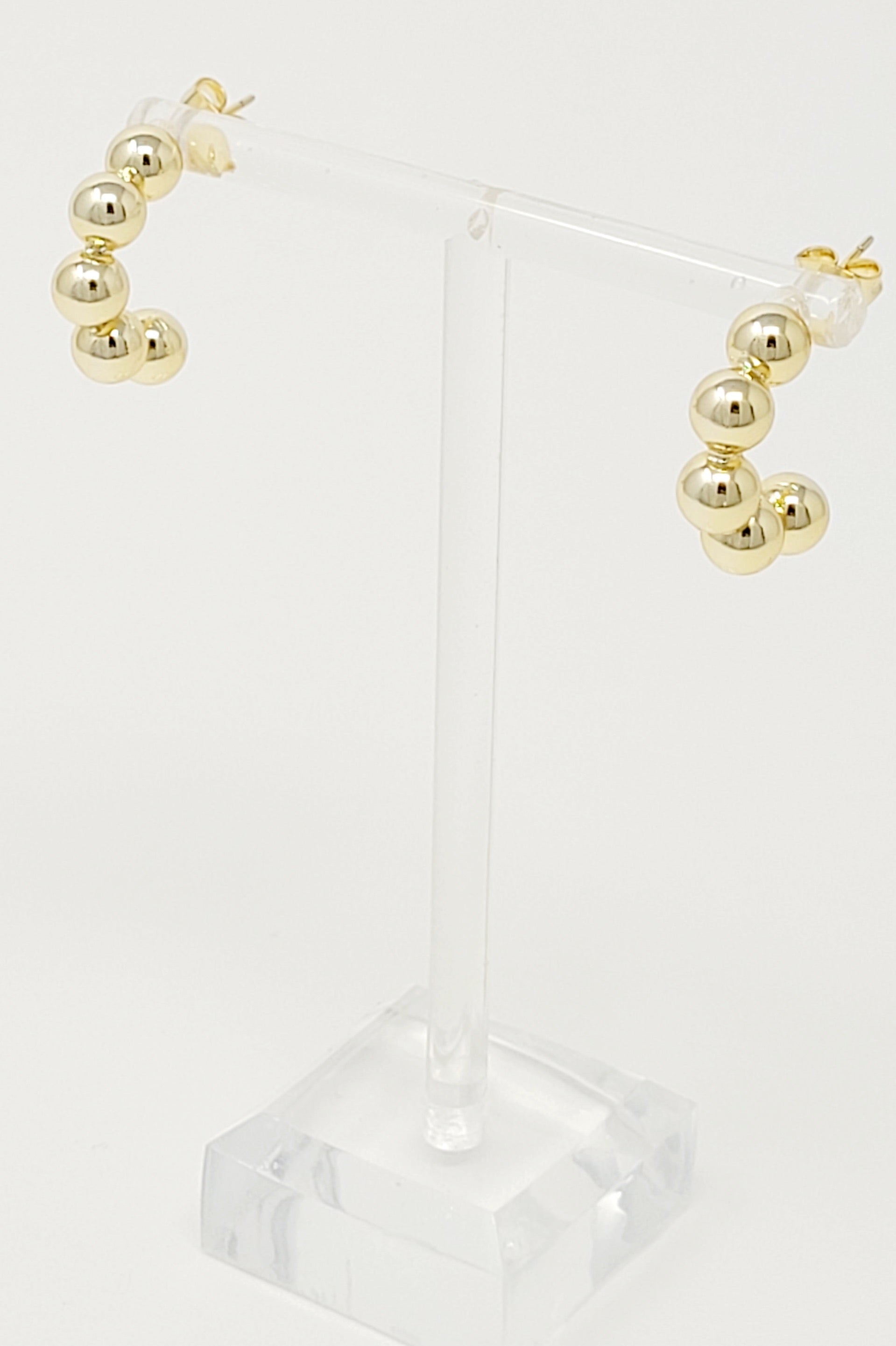 Elegant Golden Dots Hoop Earrings made of 18K gold plated brass, featuring a chic and edgy design.