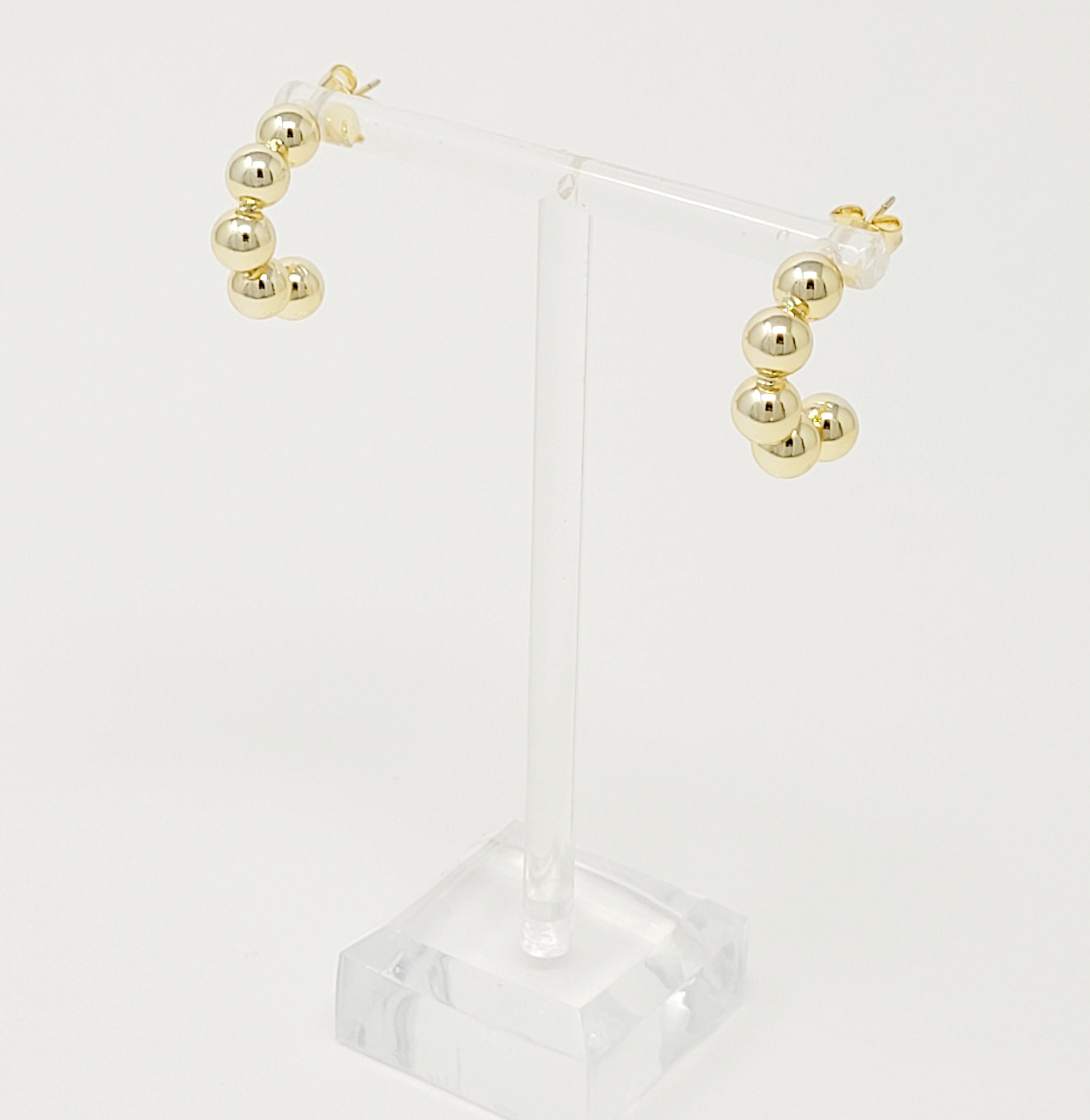 Elegant Golden Dots Hoop Earrings made of 18K gold plated brass, featuring a chic and edgy design.