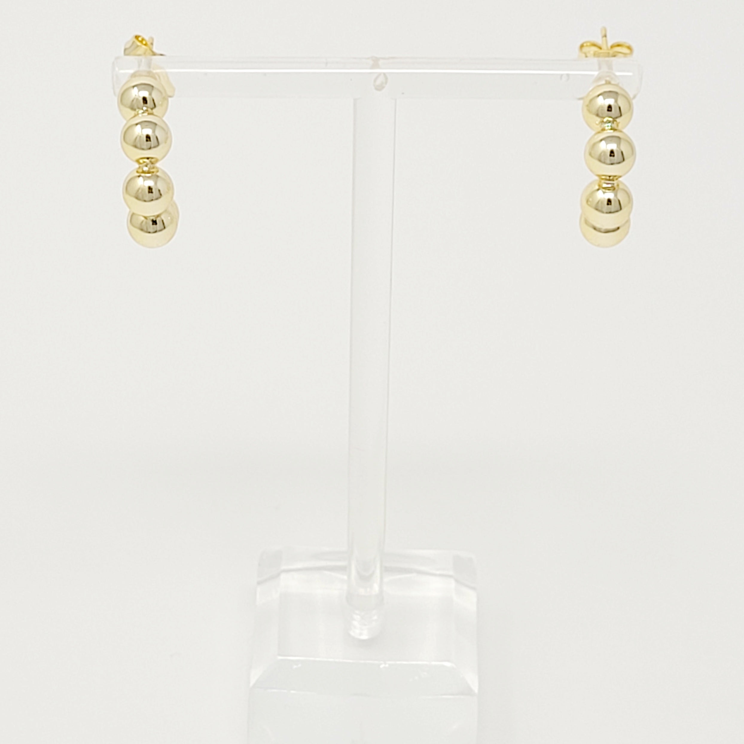 Elegant Golden Dots Hoop Earrings made of 18K gold plated brass, featuring a chic and edgy design.