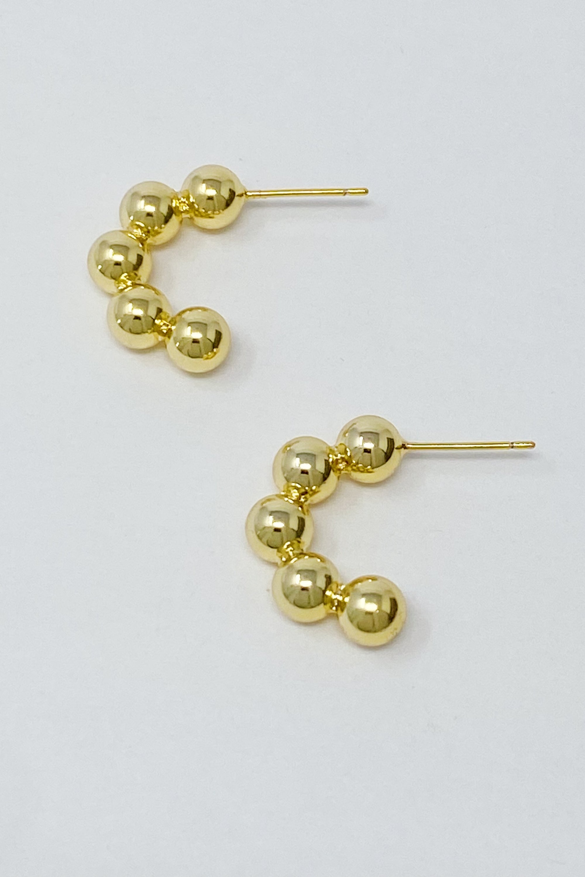 Elegant Golden Dots Hoop Earrings made of 18K gold plated brass, featuring a chic and edgy design.