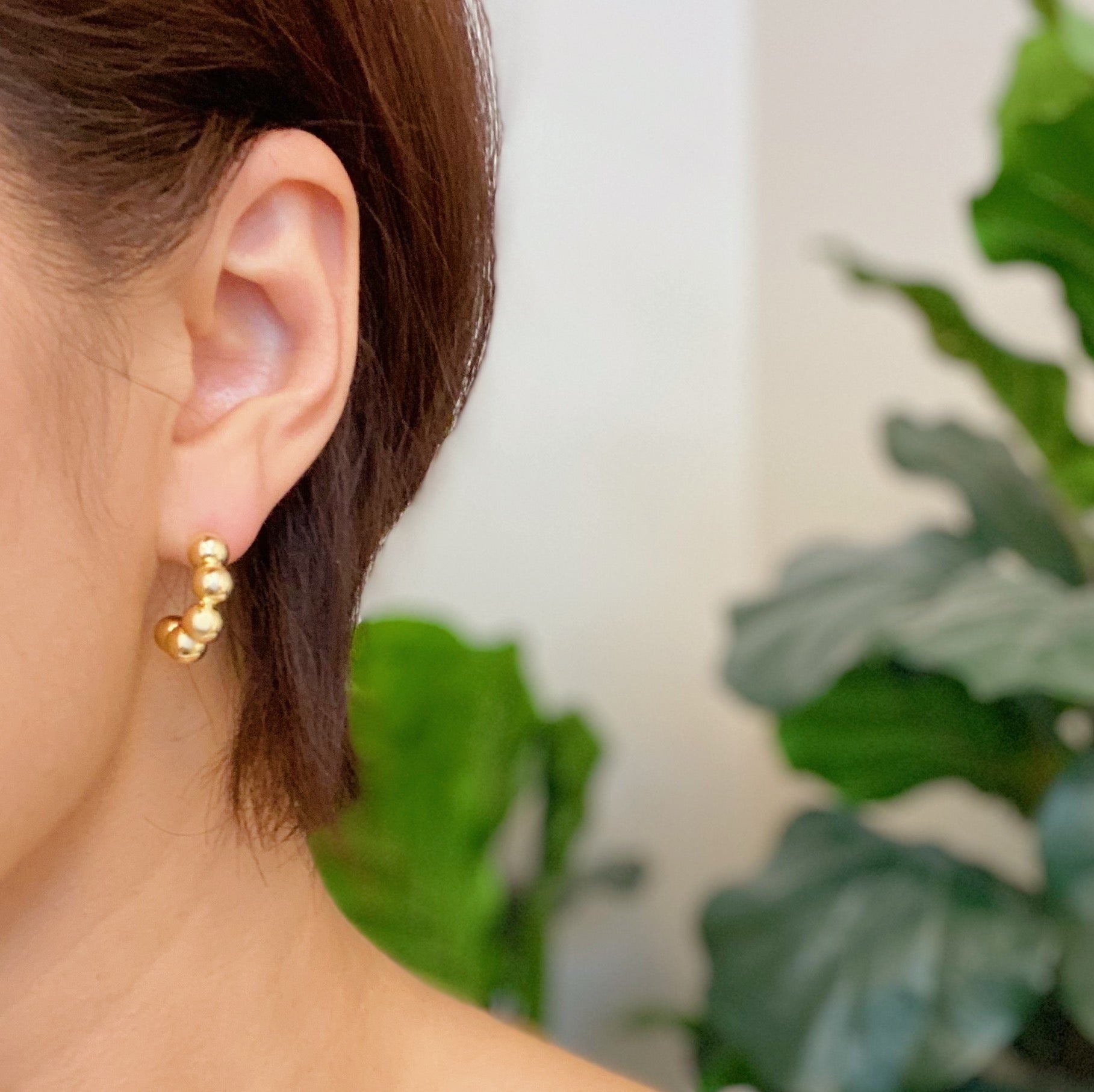 Elegant Golden Dots Hoop Earrings made of 18K gold plated brass, featuring a chic and edgy design.