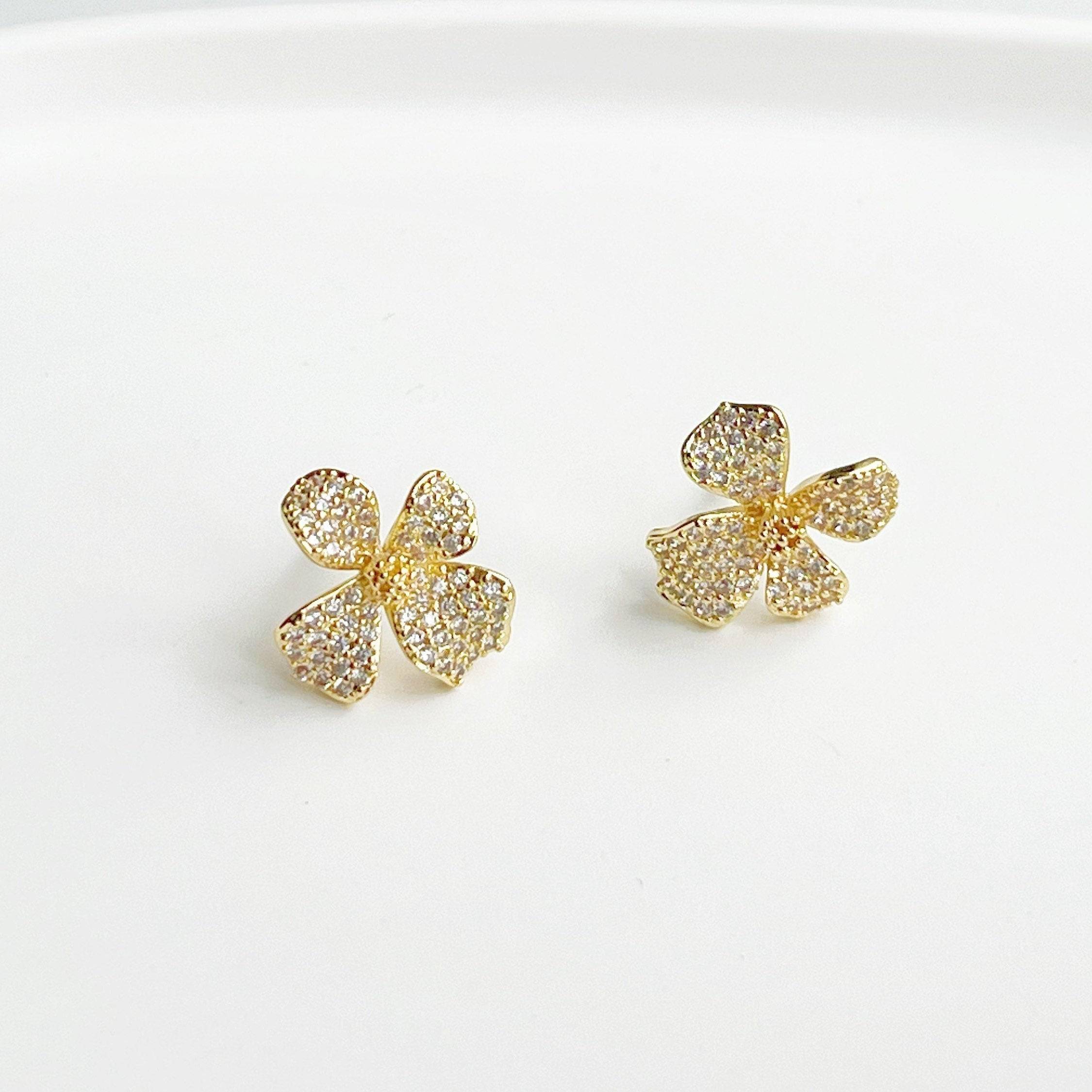 Golden Four Petals Shamrock Earrings featuring gold-plated bronze, sterling silver studs, and sparkling artificial crystals.