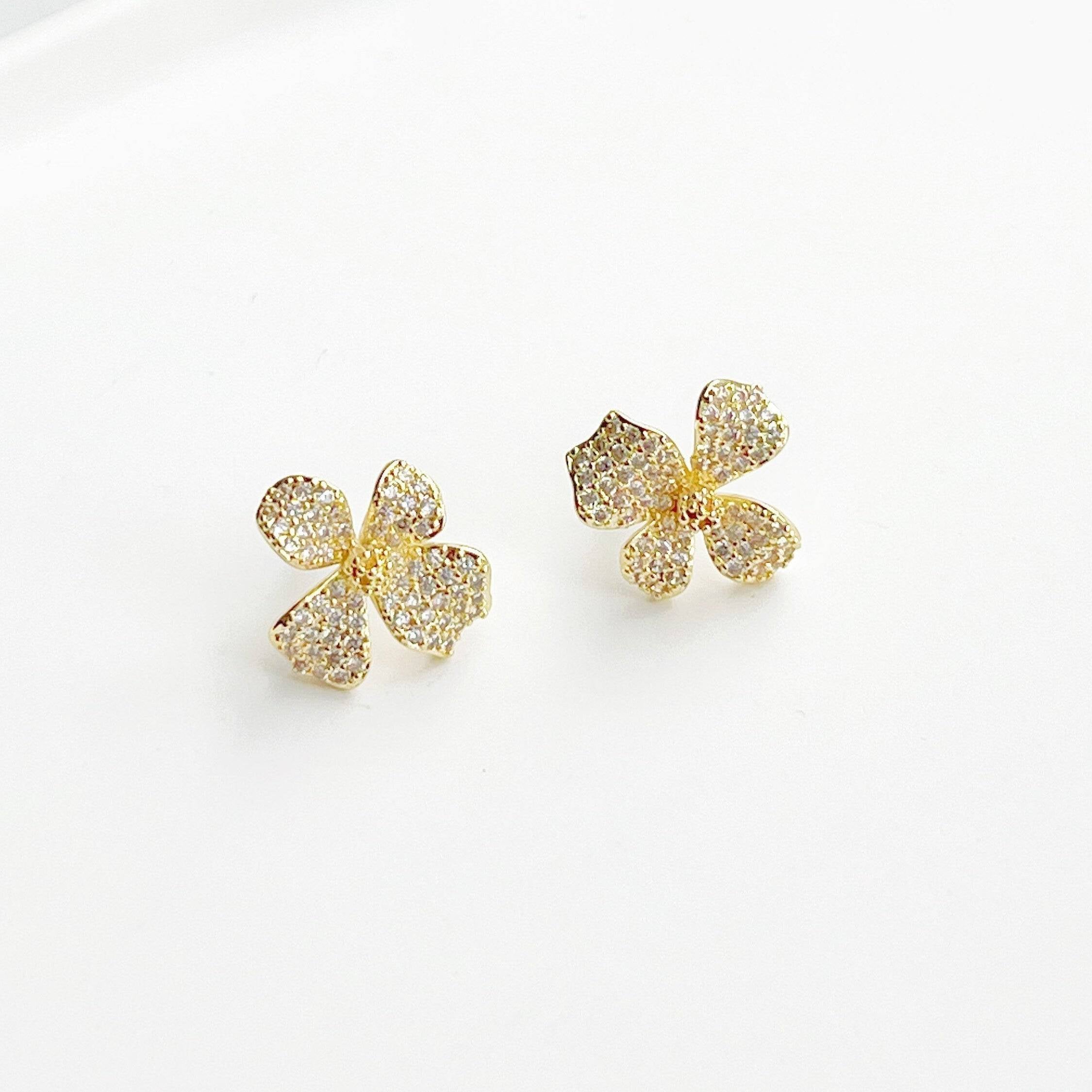 Golden Four Petals Shamrock Earrings featuring gold-plated bronze, sterling silver studs, and sparkling artificial crystals.