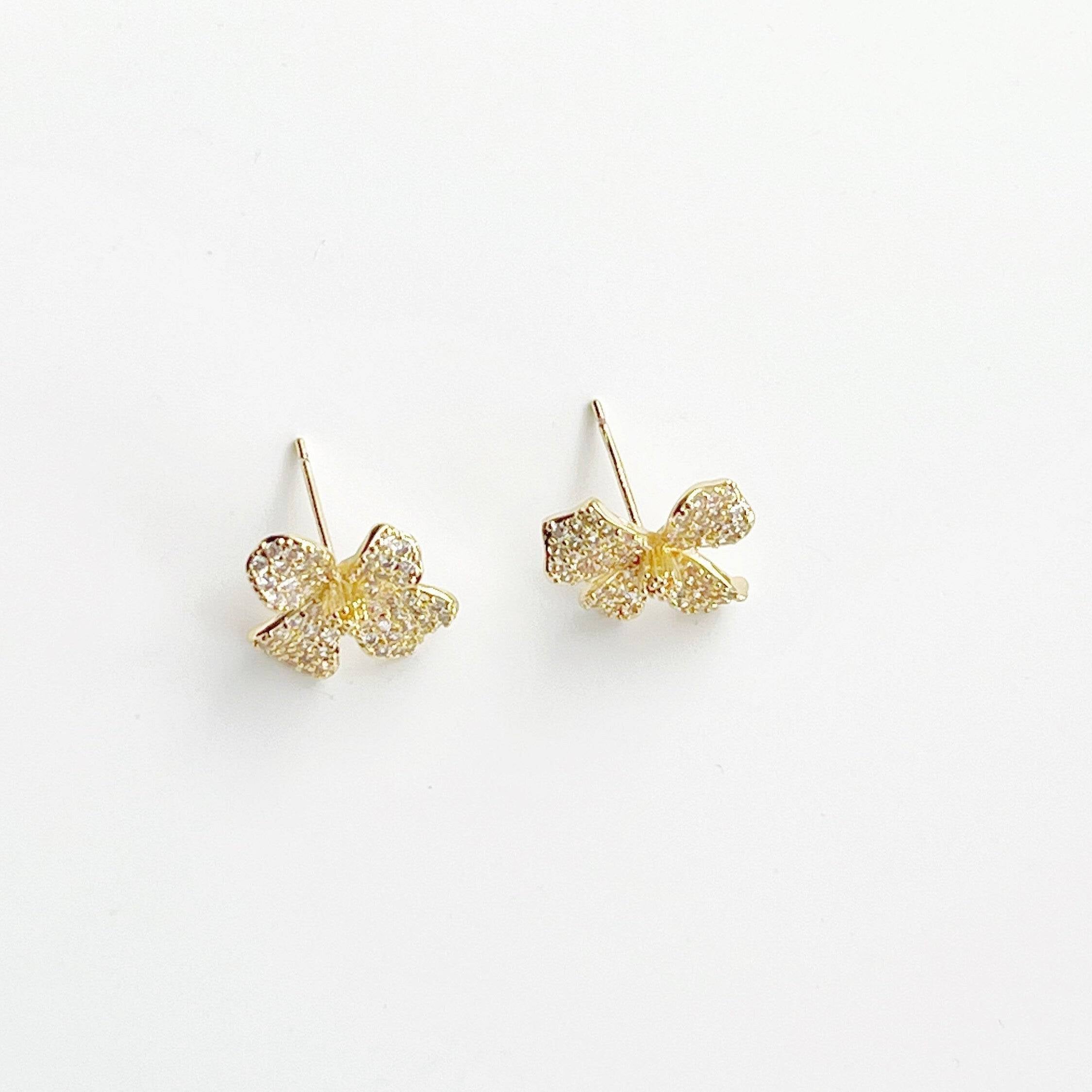 Golden Four Petals Shamrock Earrings featuring gold-plated bronze, sterling silver studs, and sparkling artificial crystals.