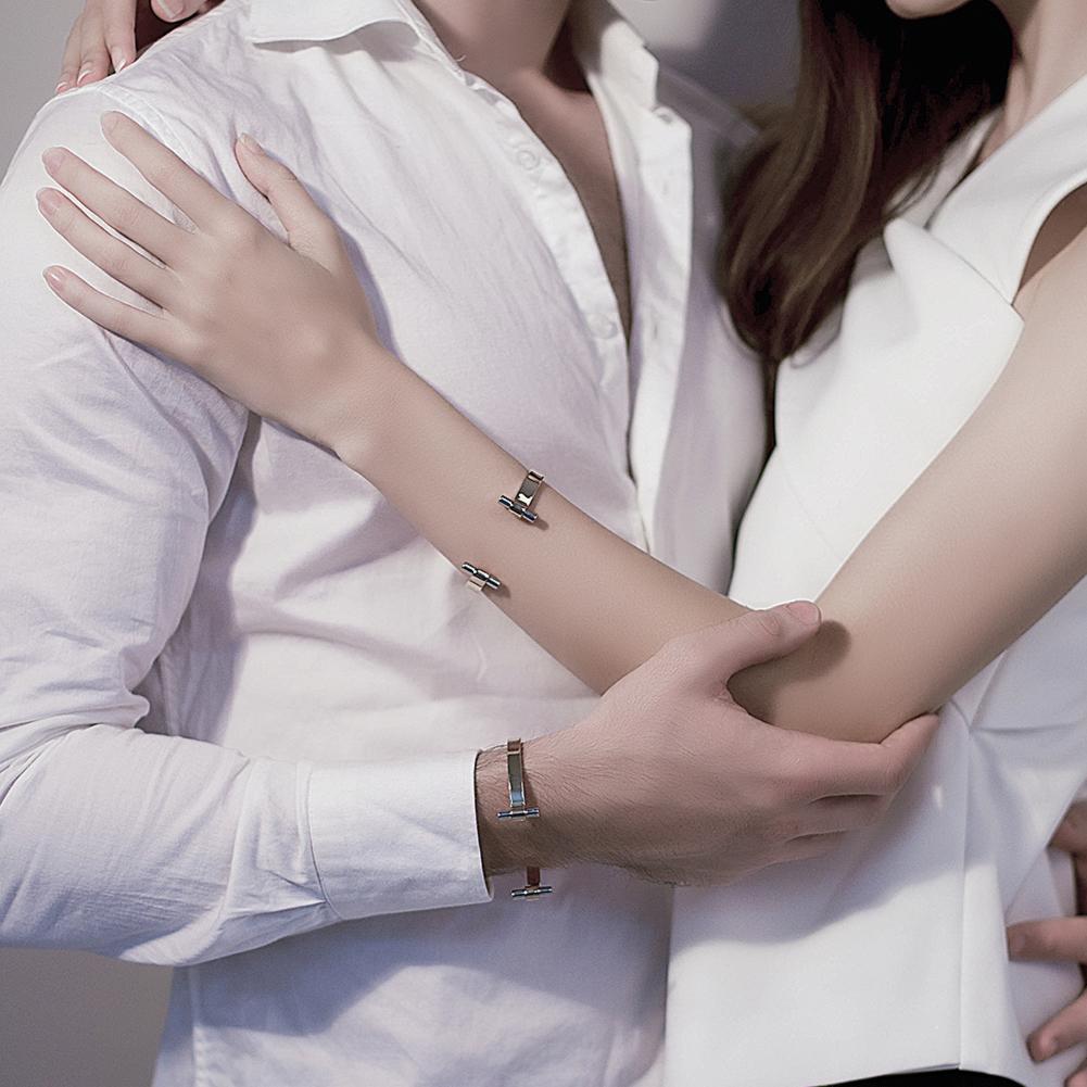 Golden Love Couple Cuff made of surgical stainless steel with 14K gold plating, showcasing a sleek and elegant design.