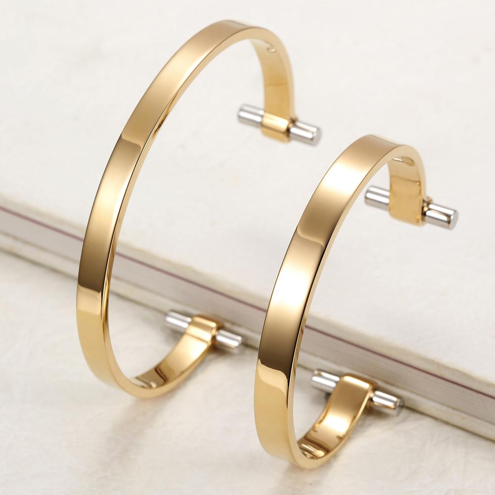 Golden Love Couple Cuff made of surgical stainless steel with 14K gold plating, showcasing a sleek and elegant design.