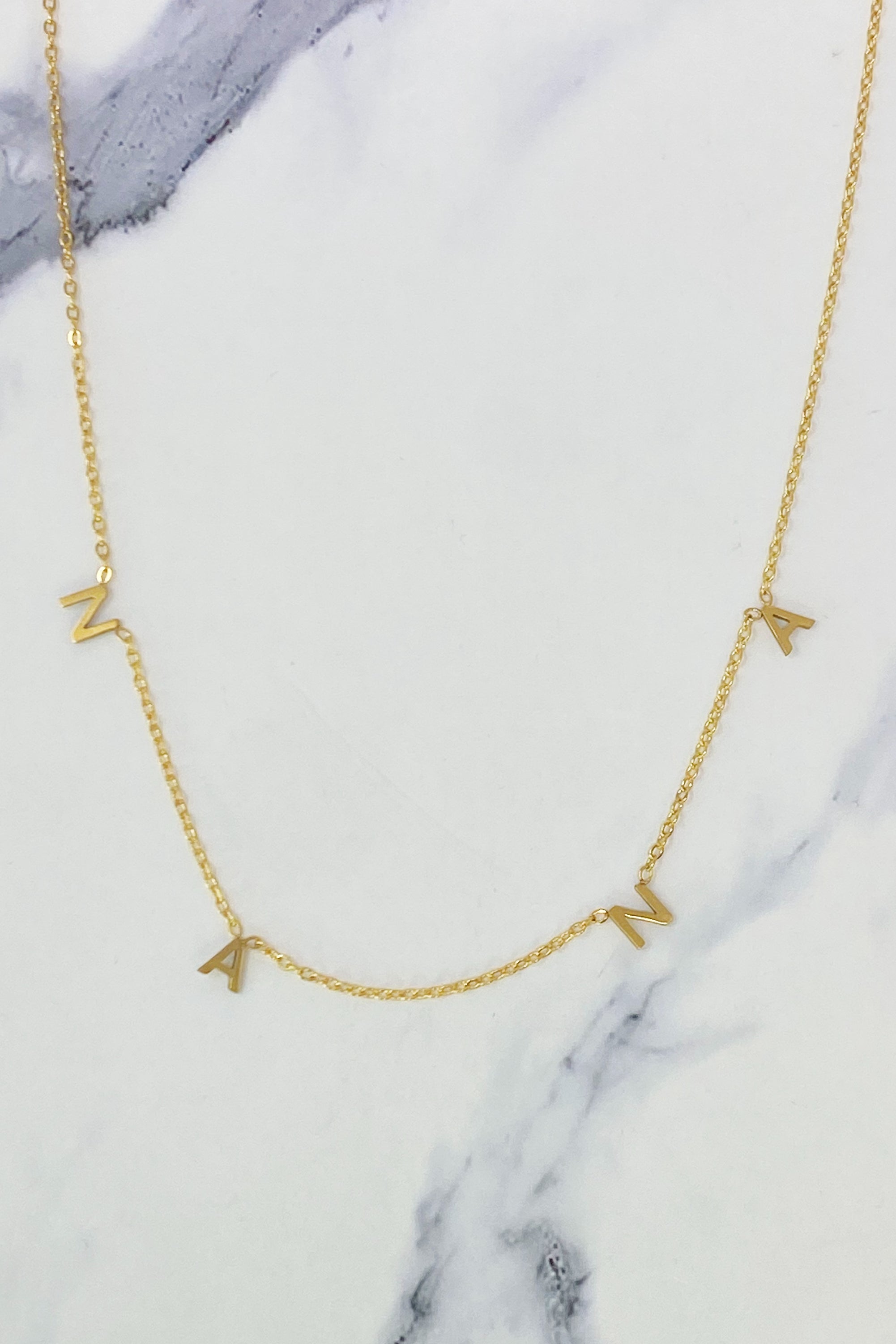 Elegant Golden Nana Necklace with a 16-inch chain and extender, crafted from gold plated stainless steel.