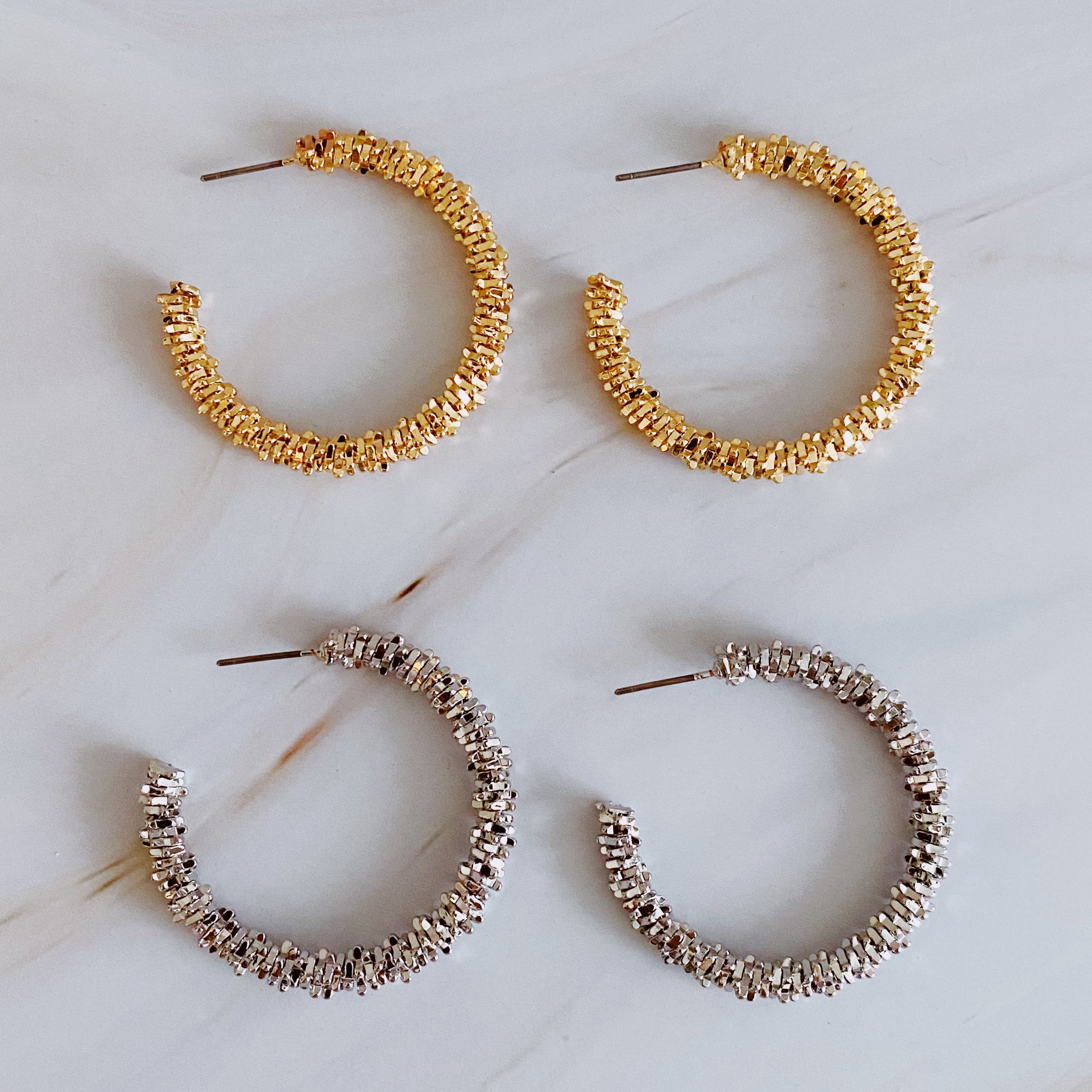 Elegant Golden Pebbles Hoop Earrings featuring small faceted metal pieces, reflecting light beautifully.