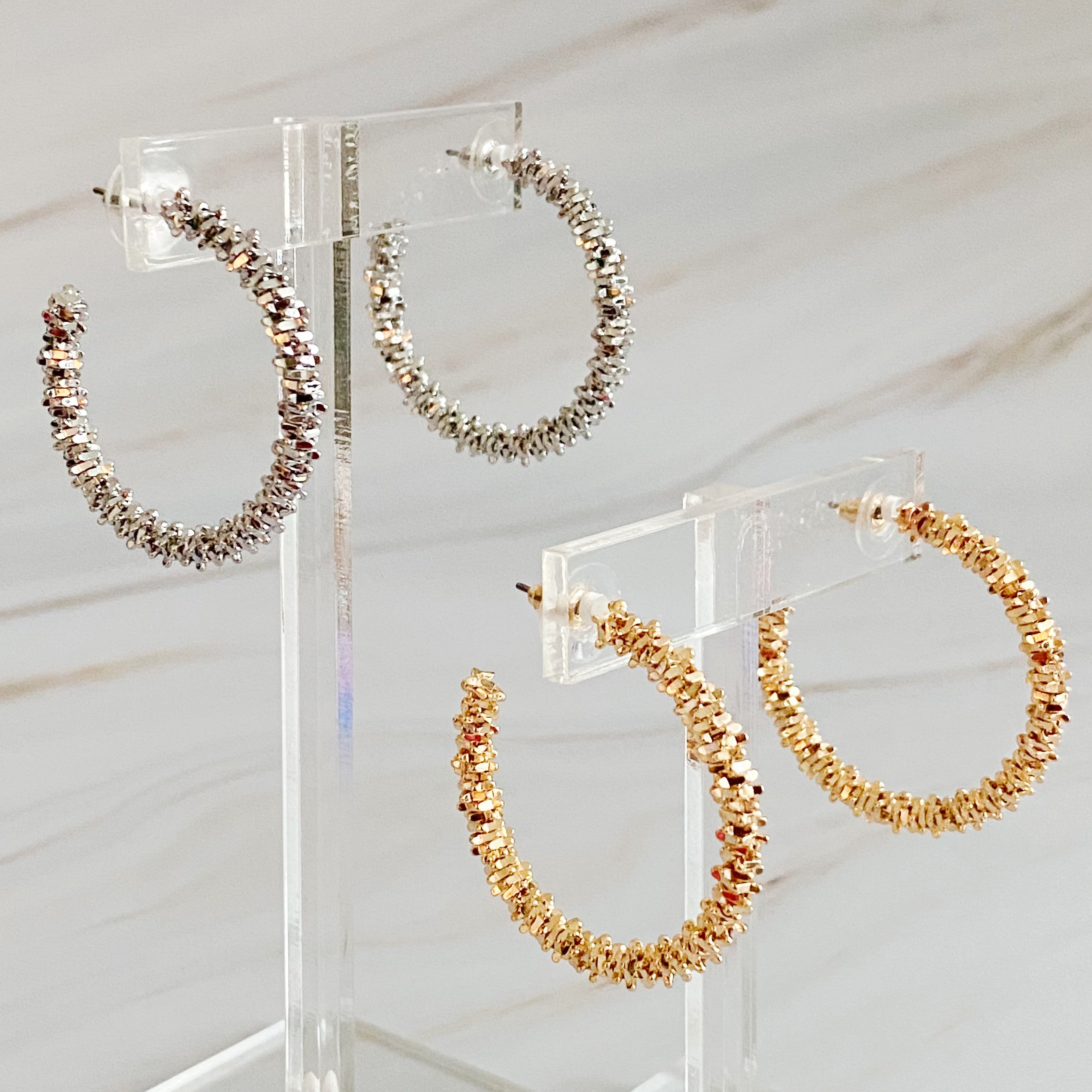 Elegant Golden Pebbles Hoop Earrings featuring small faceted metal pieces, reflecting light beautifully.