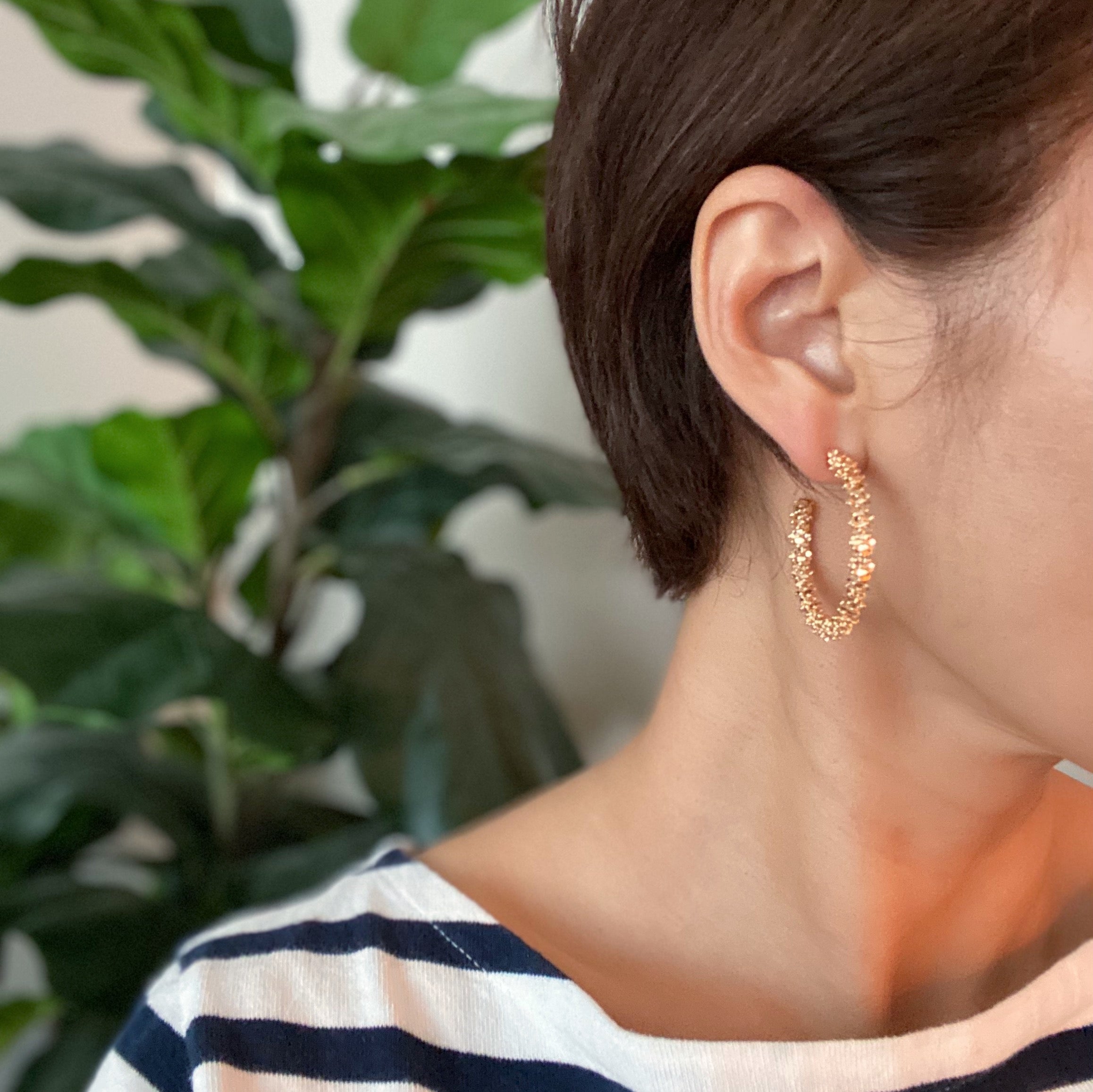 Elegant Golden Pebbles Hoop Earrings featuring small faceted metal pieces, reflecting light beautifully.