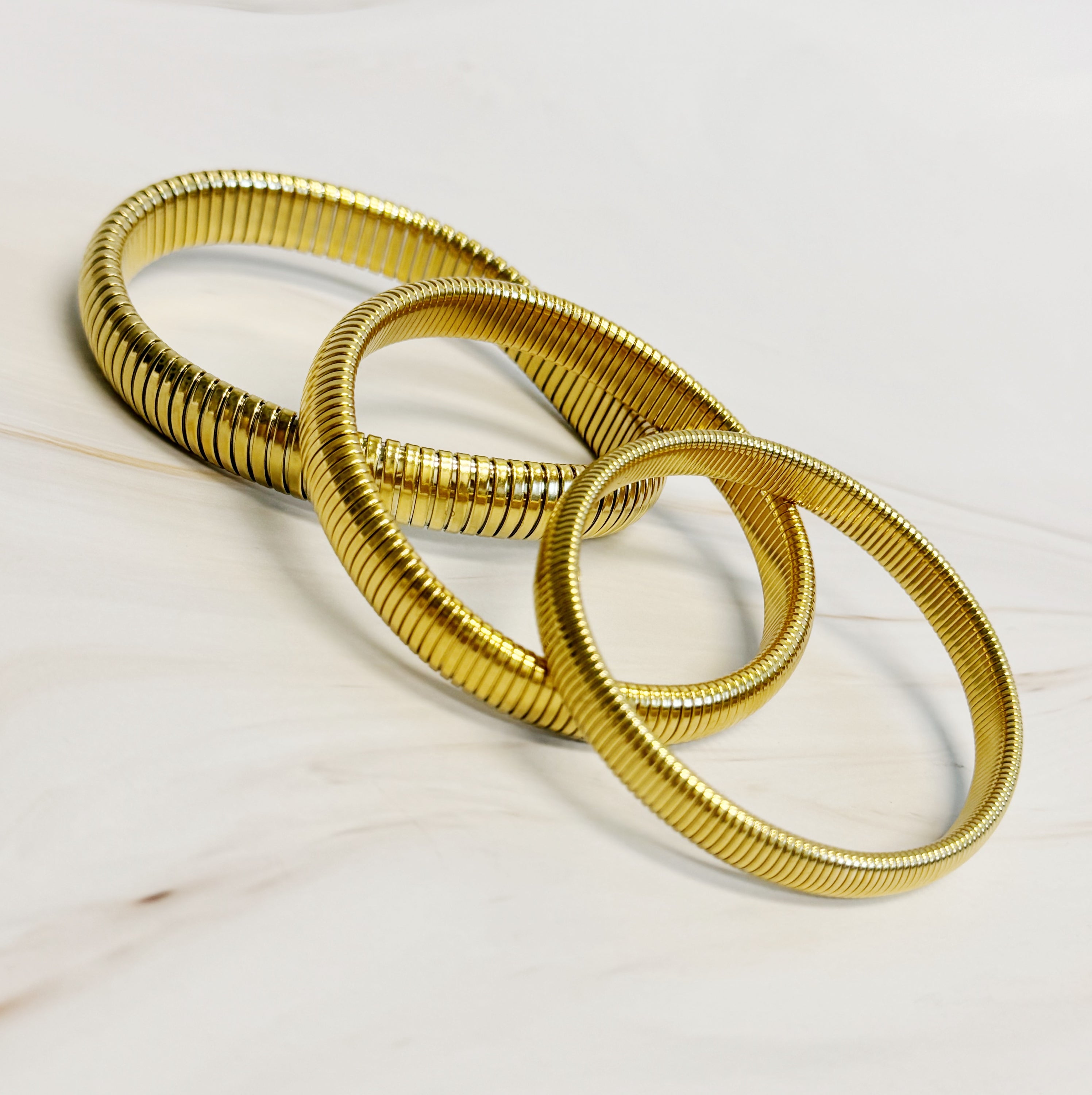 Golden Spring Soft Bangle Bracelet featuring a unique golden spring design, crafted from 18k gold plated stainless steel.