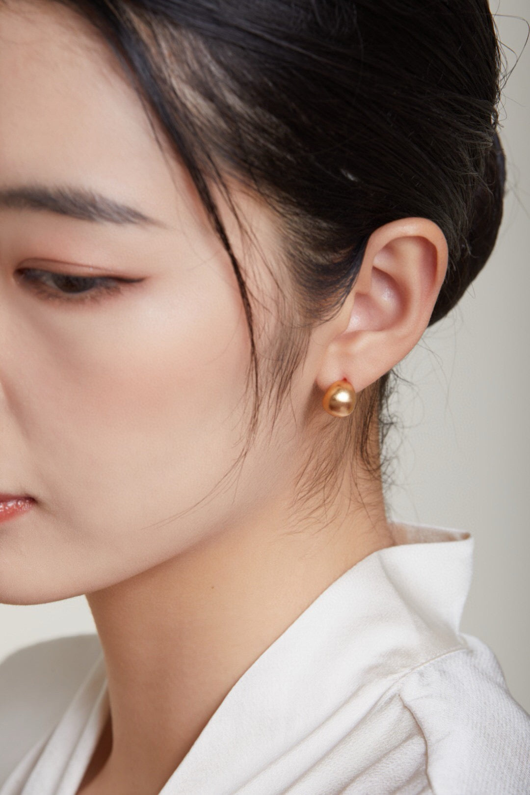 Gold-plated brushed spherical stud earrings, handmade with 18ct gold plating on sterling silver, showcasing a unique brushed texture.