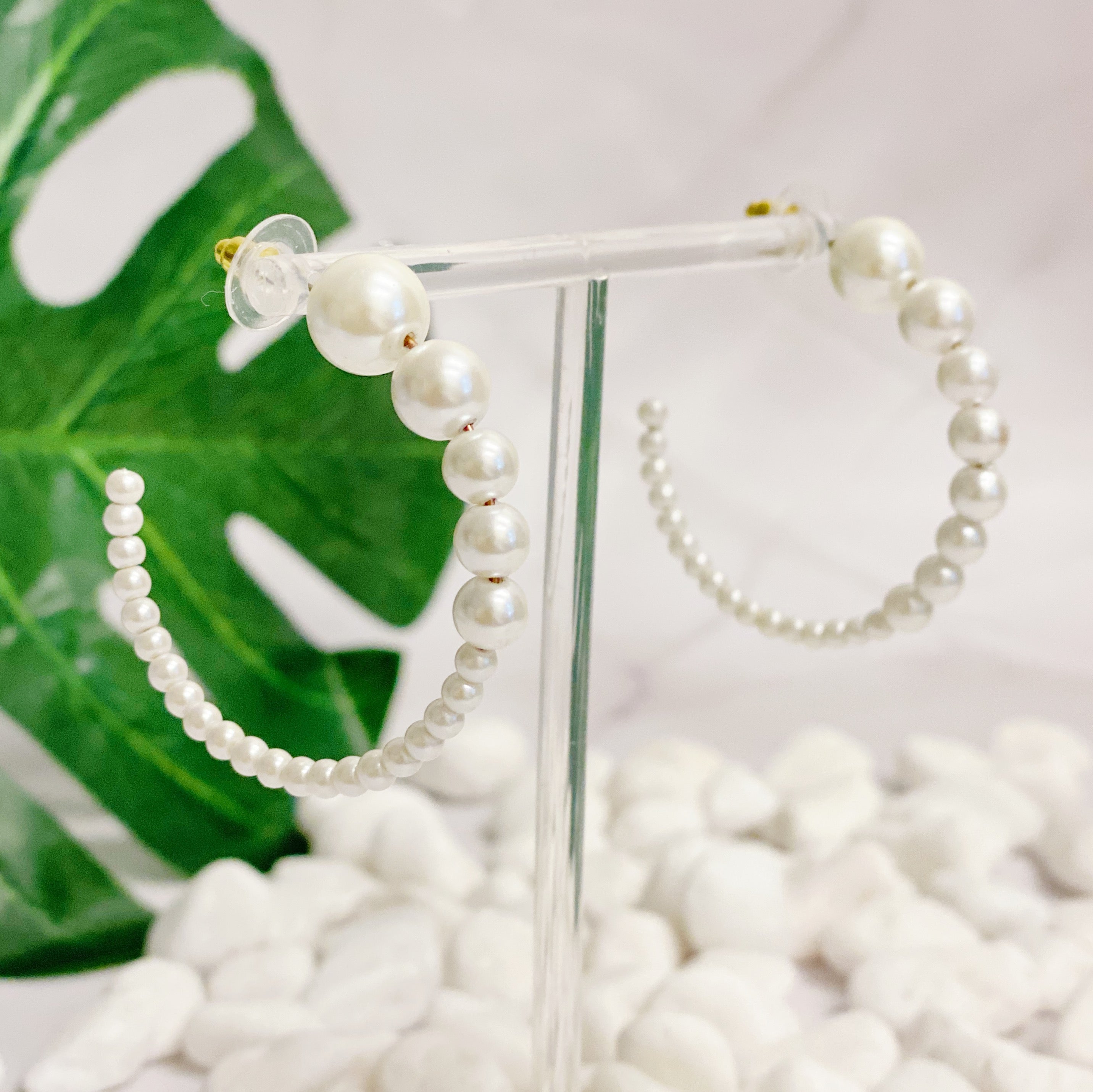 Stylish Gradation Bauble Hoop Earrings featuring a unique arrangement of large and small beads in a hoop design.