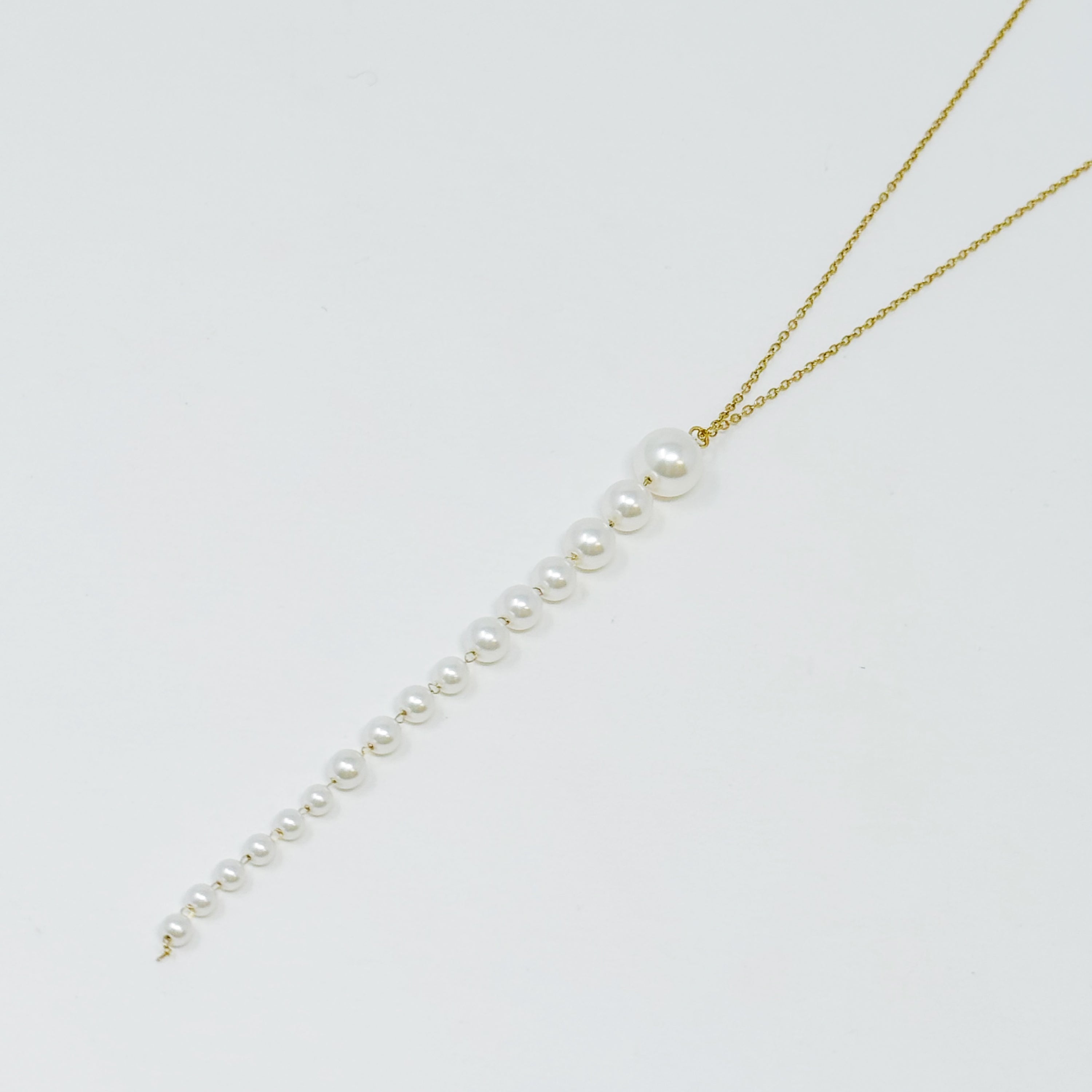 Gradiant Long Pearl Drop Necklace featuring elegant faux pearls and 18k gold plated stainless steel chain.