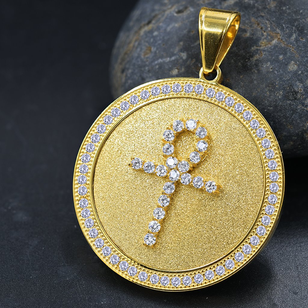 GRANDEUR Steel Pendant featuring an ankh cross design with cubic zirconia stones, elegantly shining against a neutral background.