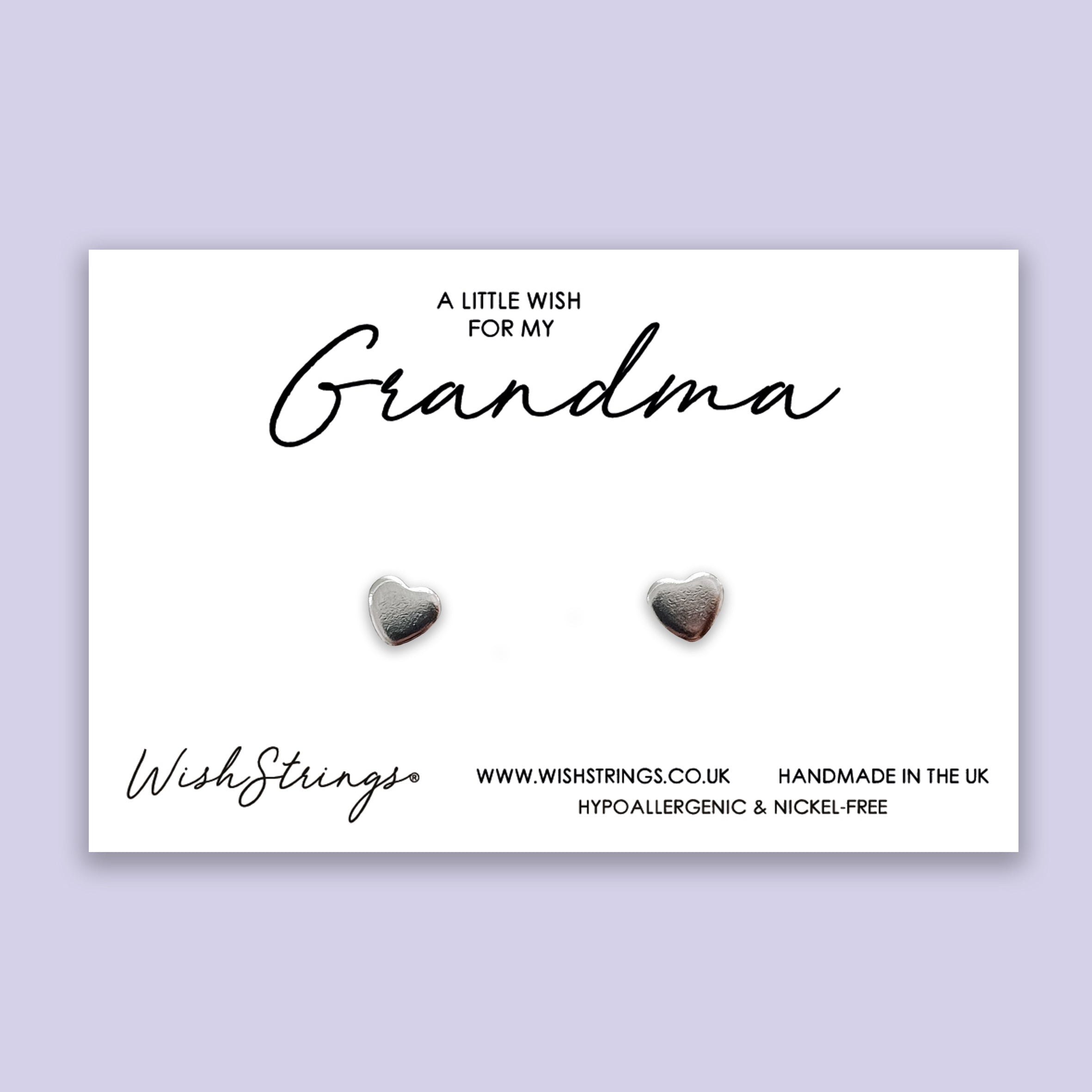 A pair of elegant silver heart stud earrings made from hypoallergenic 304 stainless steel, displayed on a gift card.