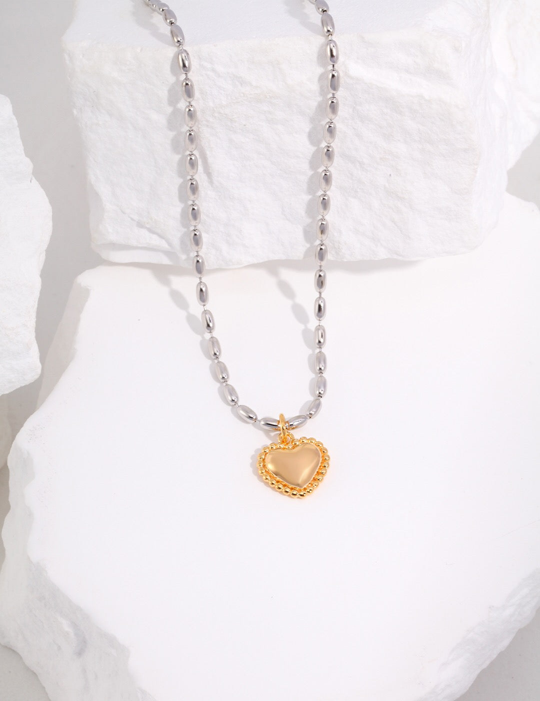 Gray Rice Pearl Necklace featuring a heart pendant, handmade with gold vermeil plating, showcasing elegance and craftsmanship.