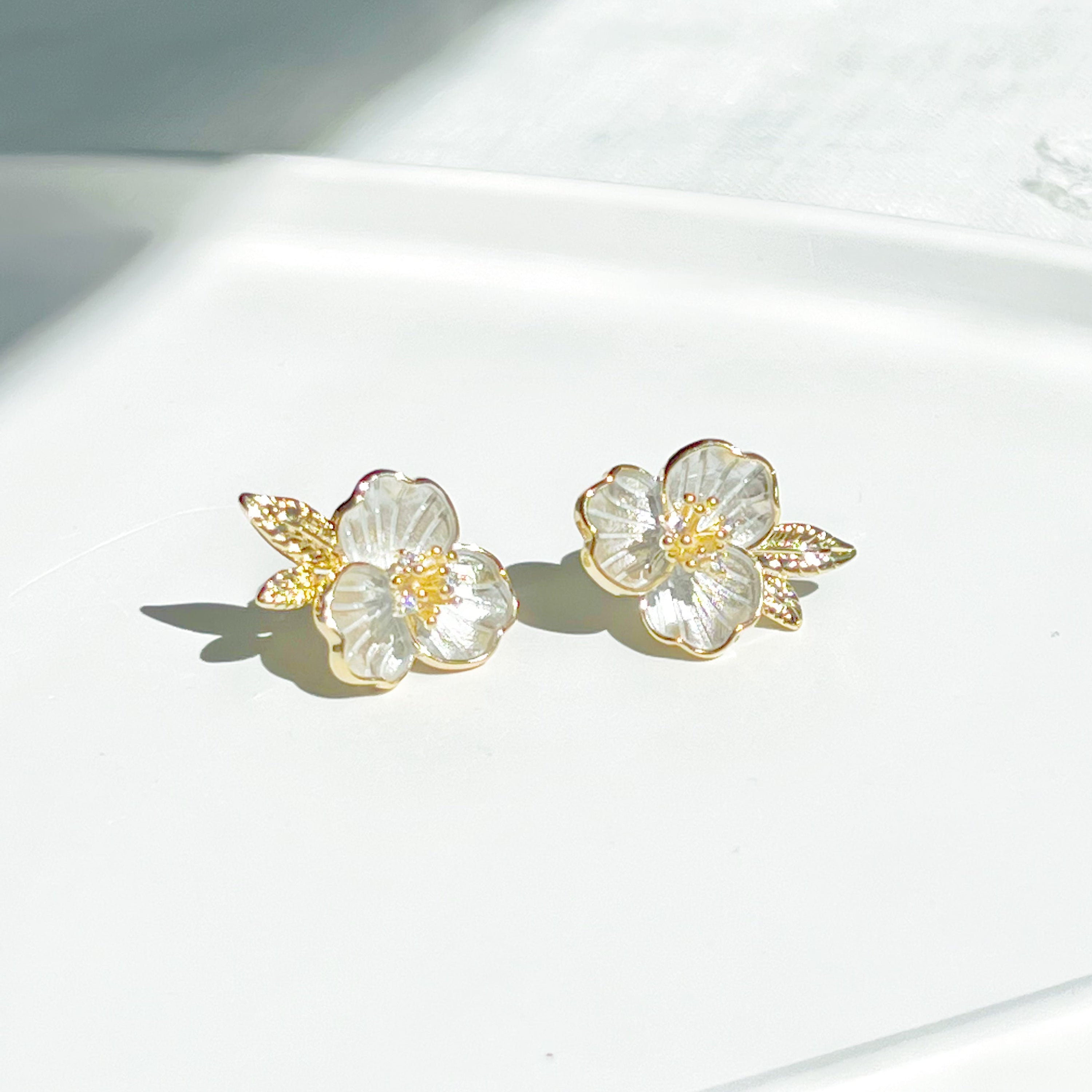 Gold and white flower earrings.