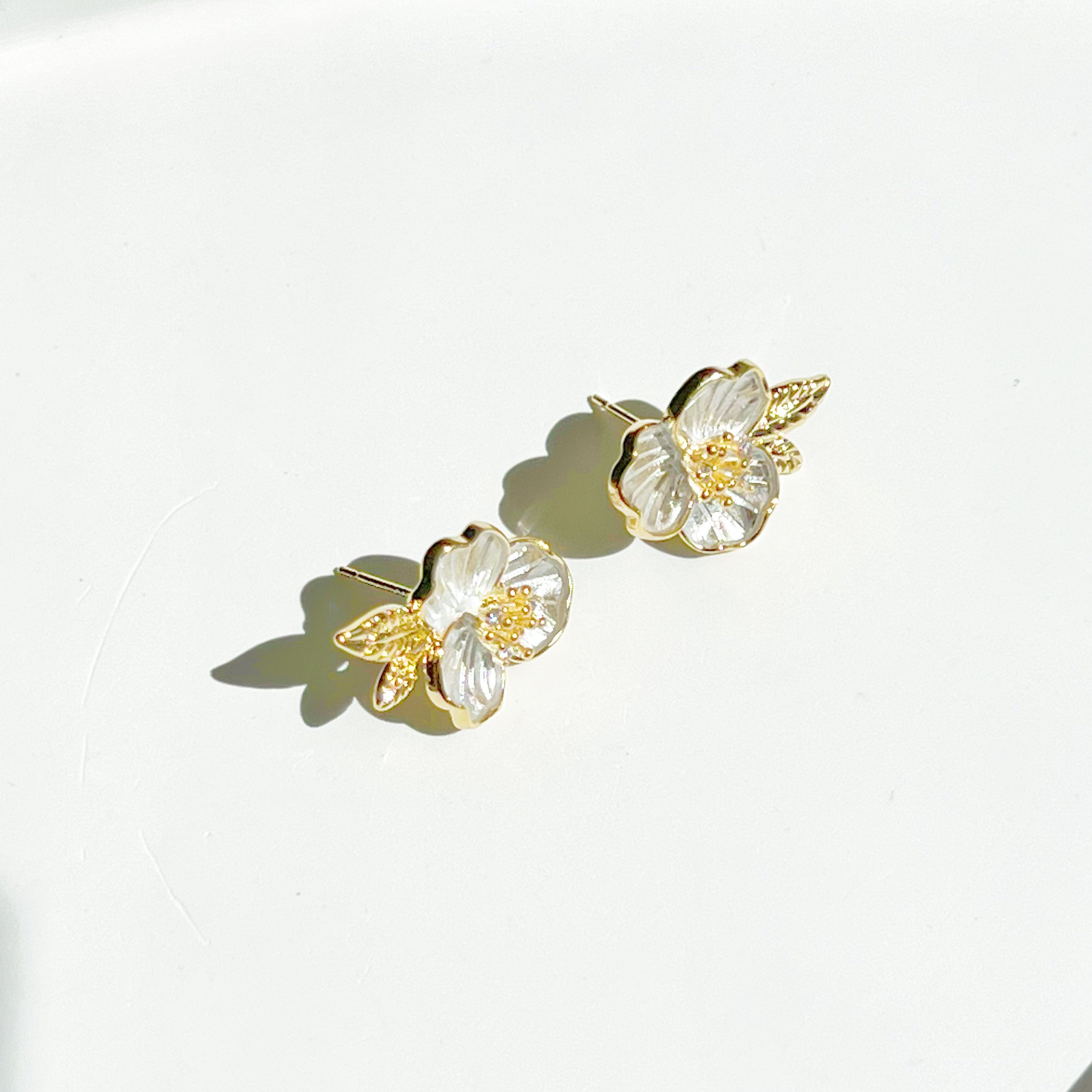 Gold and white flower earrings.