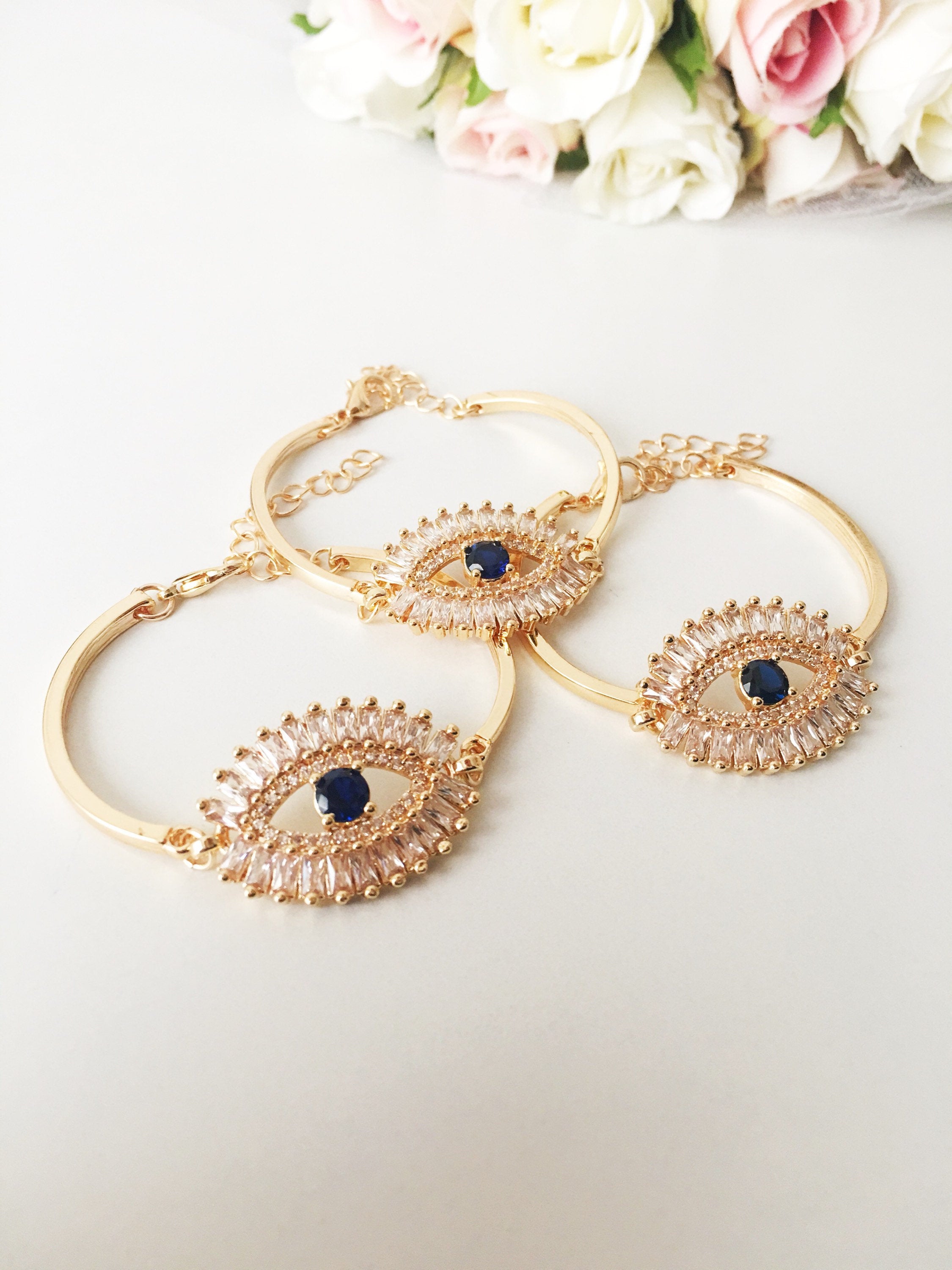 A beautiful Greek Evil Eye Bracelet featuring a sparkling cubic zirconia baguette design, available in silver, gold, and rose gold finishes.