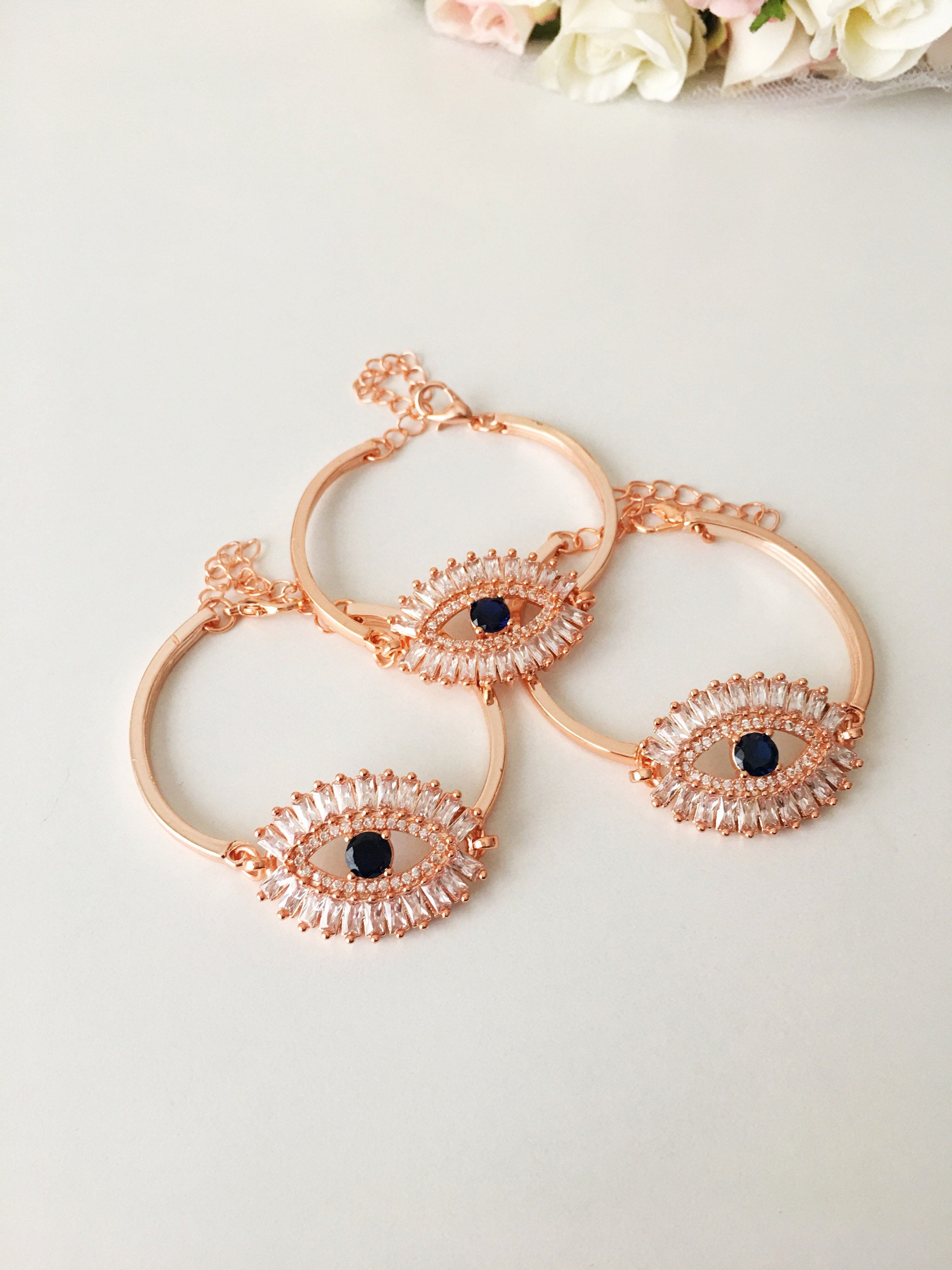 A beautiful Greek Evil Eye Bracelet featuring a sparkling cubic zirconia baguette design, available in silver, gold, and rose gold finishes.