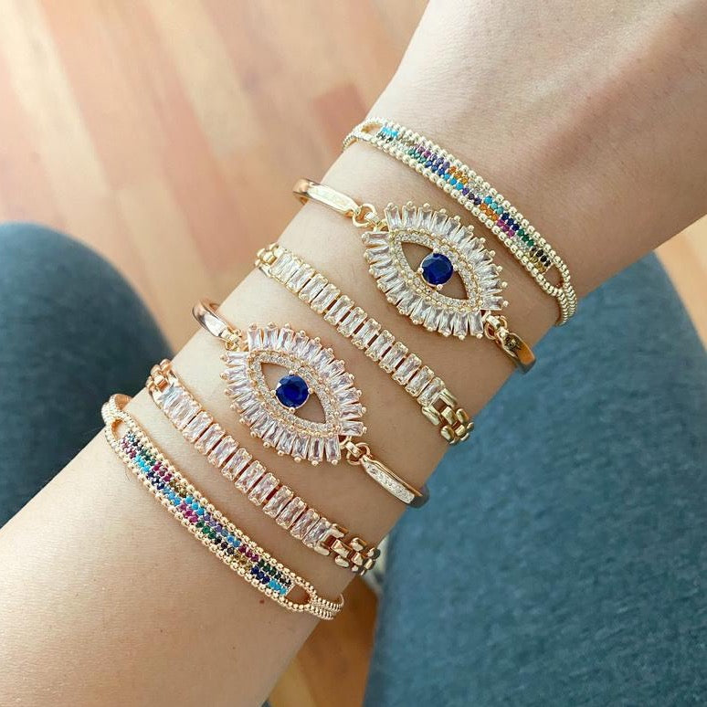 A beautiful Greek Evil Eye Bracelet featuring rainbow zircon stones, adjustable design, and available in rose gold and gold finishes.