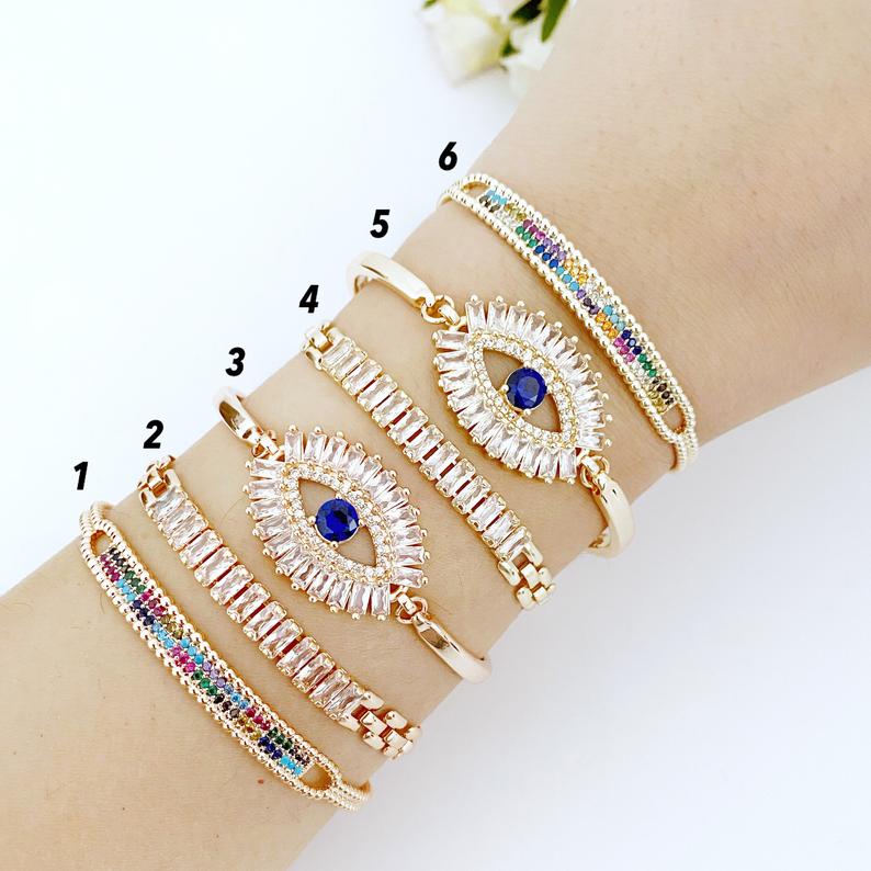 A beautiful Greek Evil Eye Bracelet featuring rainbow zircon stones, adjustable design, and available in rose gold and gold finishes.