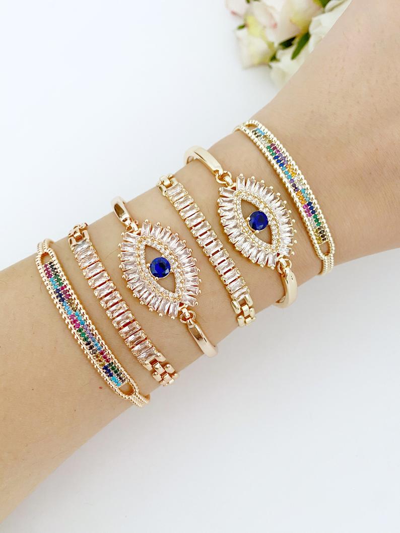 A beautiful Greek Evil Eye Bracelet featuring rainbow zircon stones, adjustable design, and available in rose gold and gold finishes.