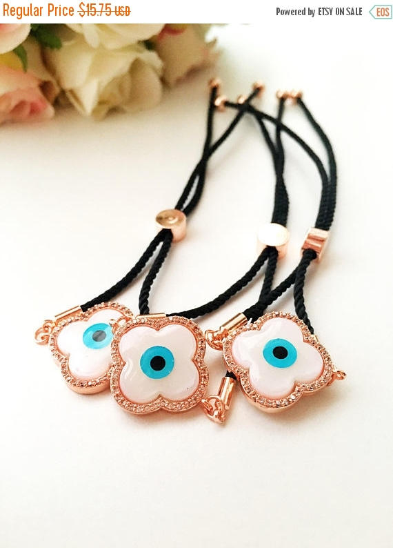 Handmade Greek Evil Eye Bracelet set in rose gold featuring Hamsa and Clover charms with zirconia accents.