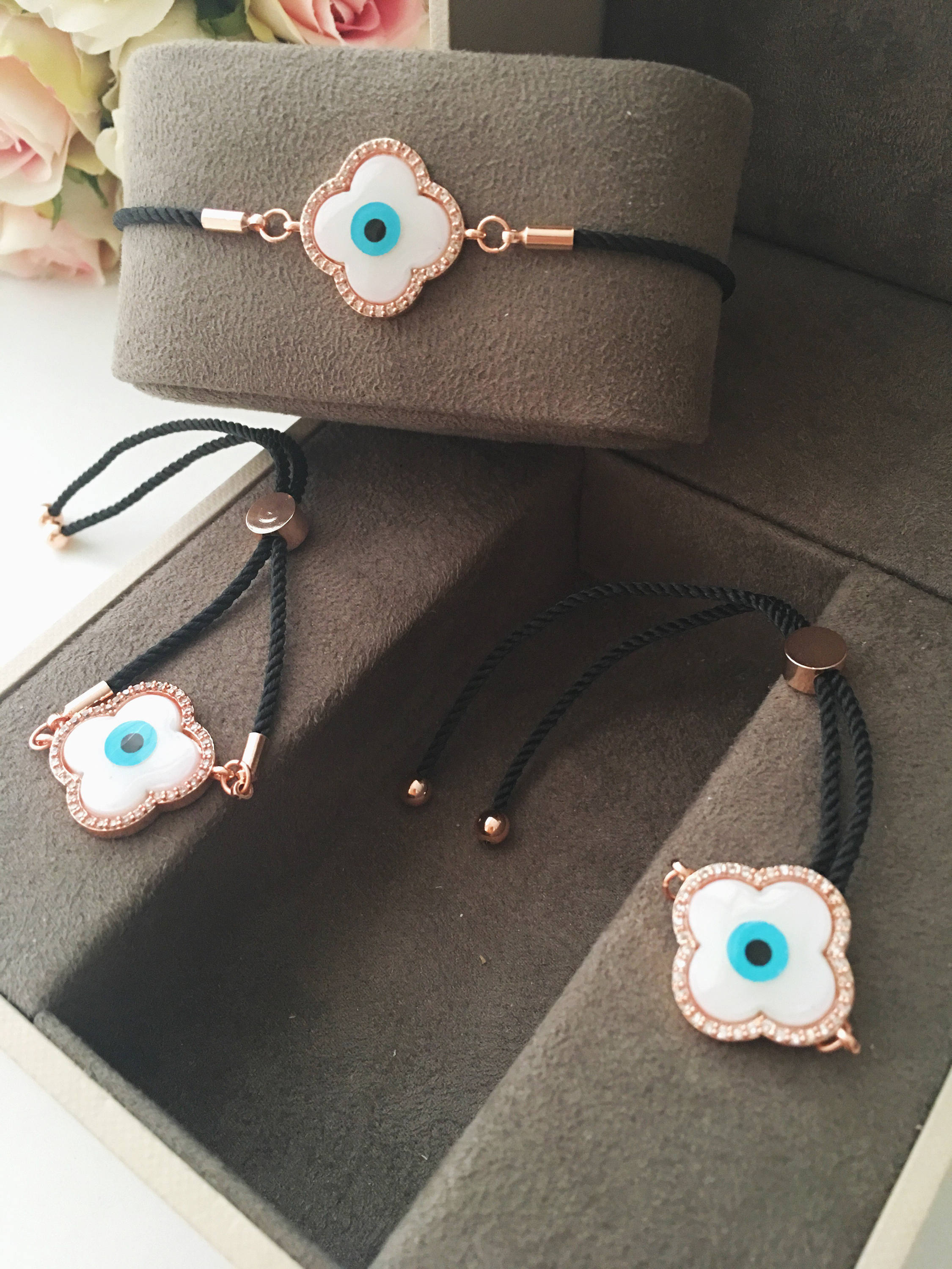 Handmade Greek Evil Eye Bracelet set in rose gold featuring Hamsa and Clover charms with zirconia accents.